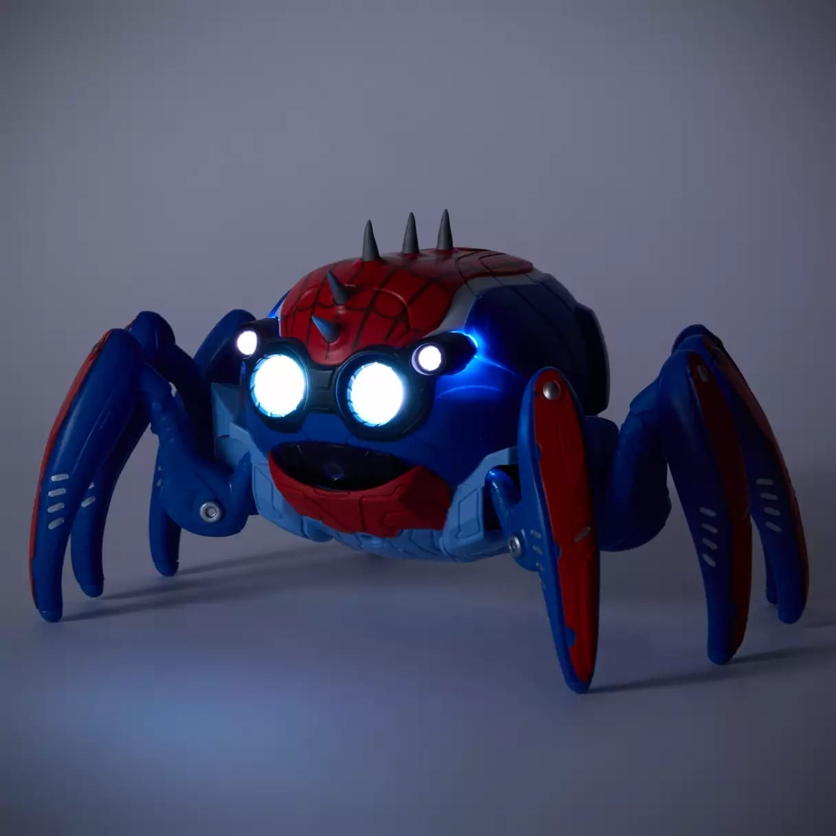 A Spider-Bot toy robot with glowing eyes and Spider-Man red and blue colors, sold at Disney Parks like Disneyland and Disney World.