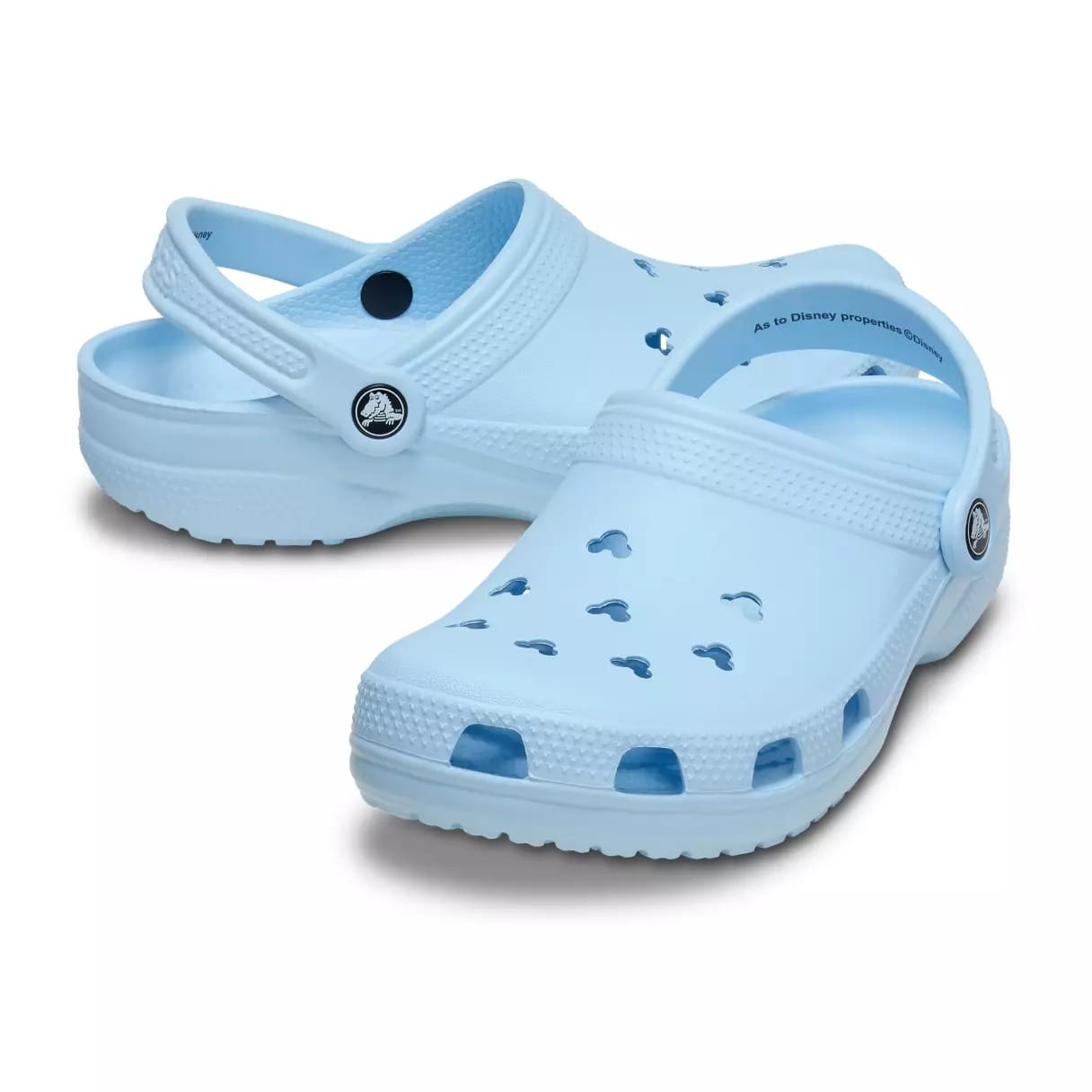 Light blue Crocs with Mickey Mouse-shaped holes and a heel strap, reminiscent of Disney Parks merchandise, on a white background.