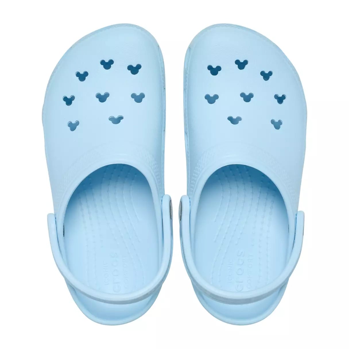 Light blue Crocs with Mickey Mouse-shaped ventilation holes, reminiscent of Disney Parks merchandise, much like seen at Disneyland.