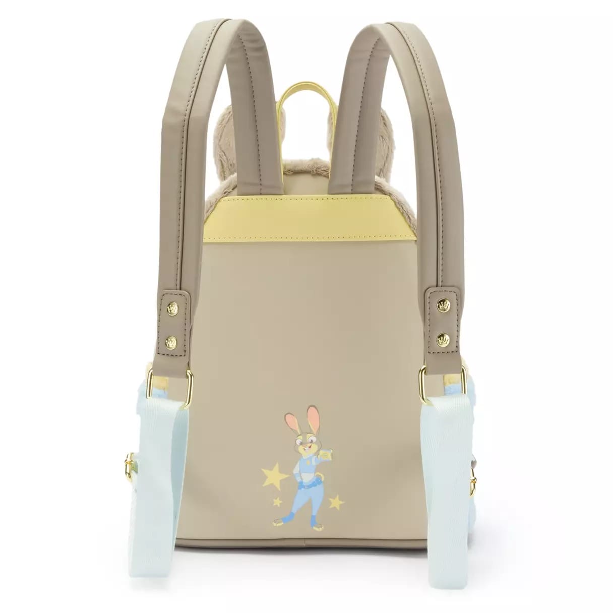 Back of a beige backpack with yellow trim featuring a rabbit in a blue outfit with stars, reminiscent of Disney park merchandise.