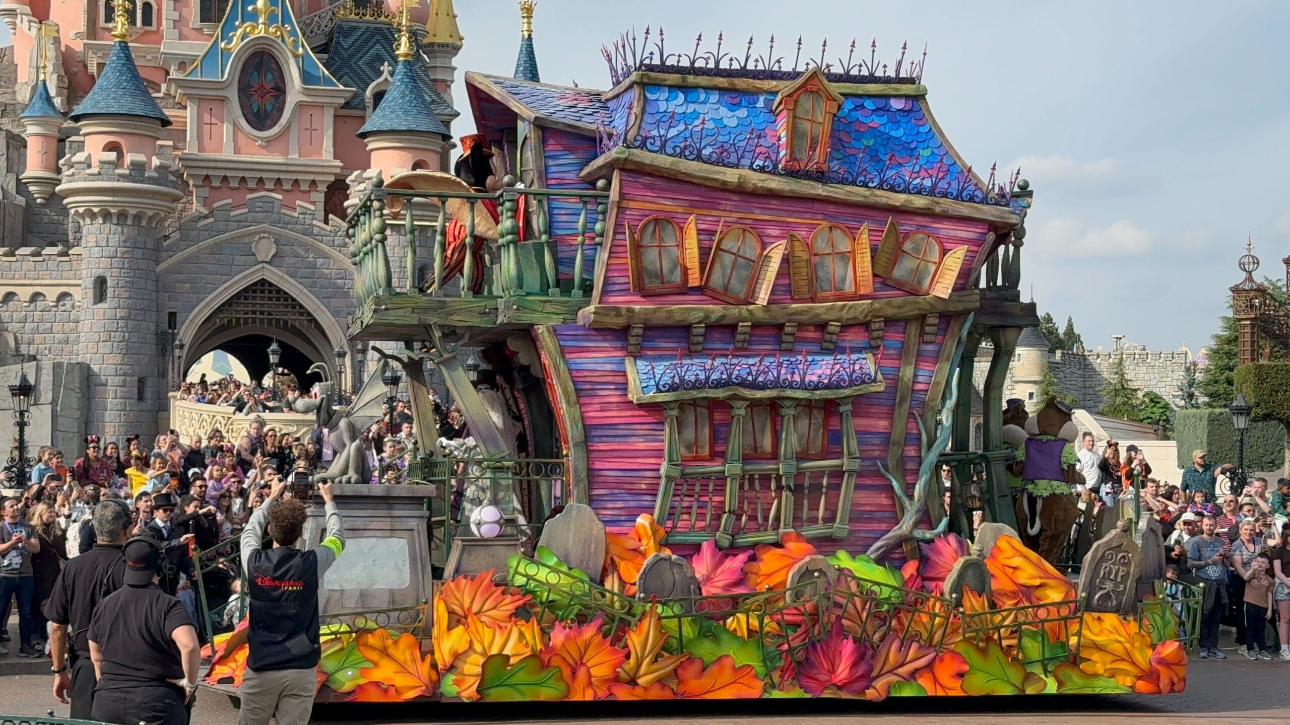 A colorful Phantom Manor float from Mickey’s Halloween Celebration parades at the 2025 Disneyland Paris castle entrance.