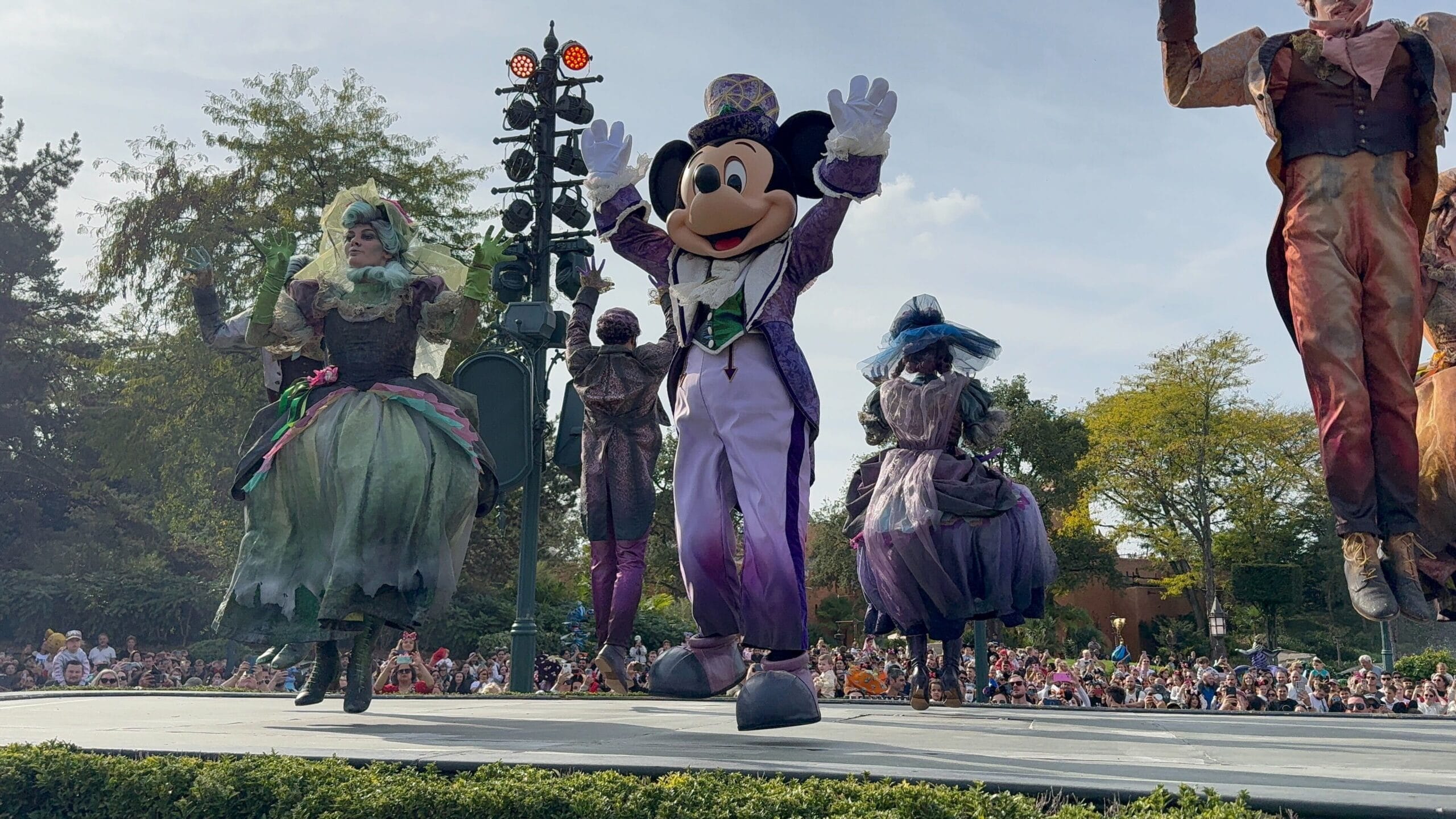 Mickey Mouse in a purple costume dances on stage during Disneyland Paris’s 2025 Mickey’s Halloween Celebration Parade.