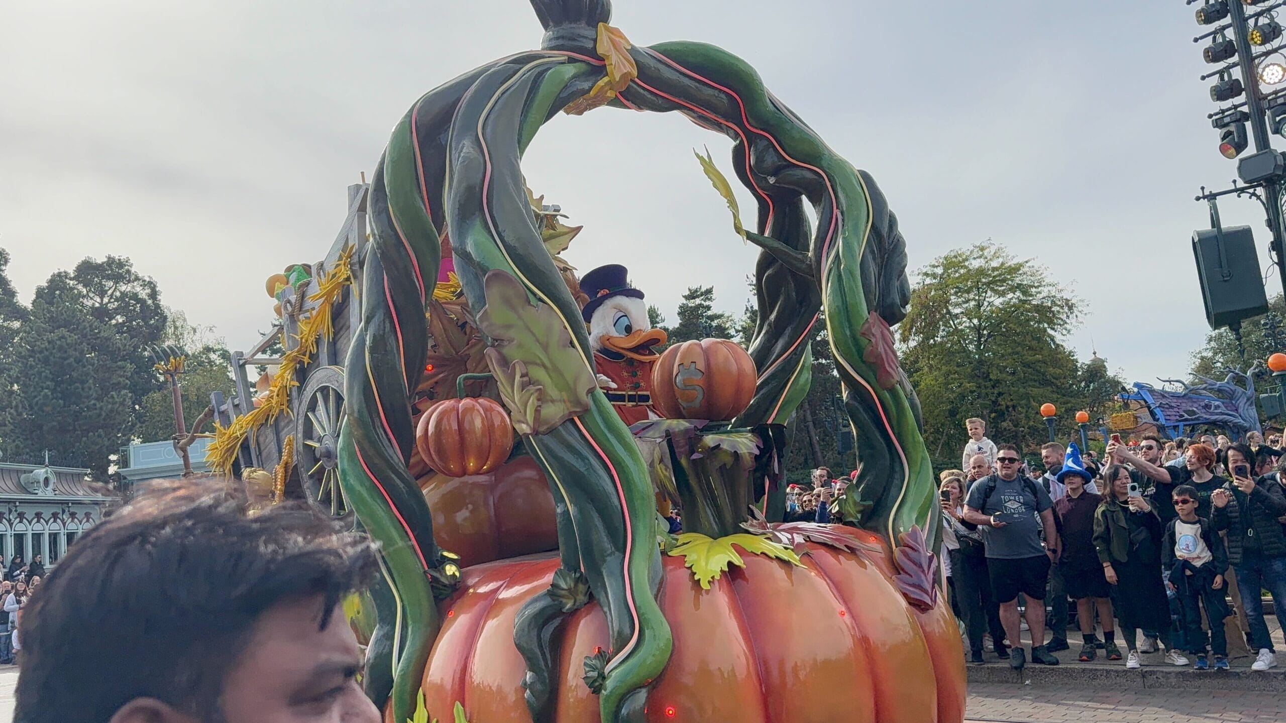 Donald Duck in costume rides a pumpkin float at the 2025 Mickey’s Halloween Celebration Parade in Disneyland Paris.