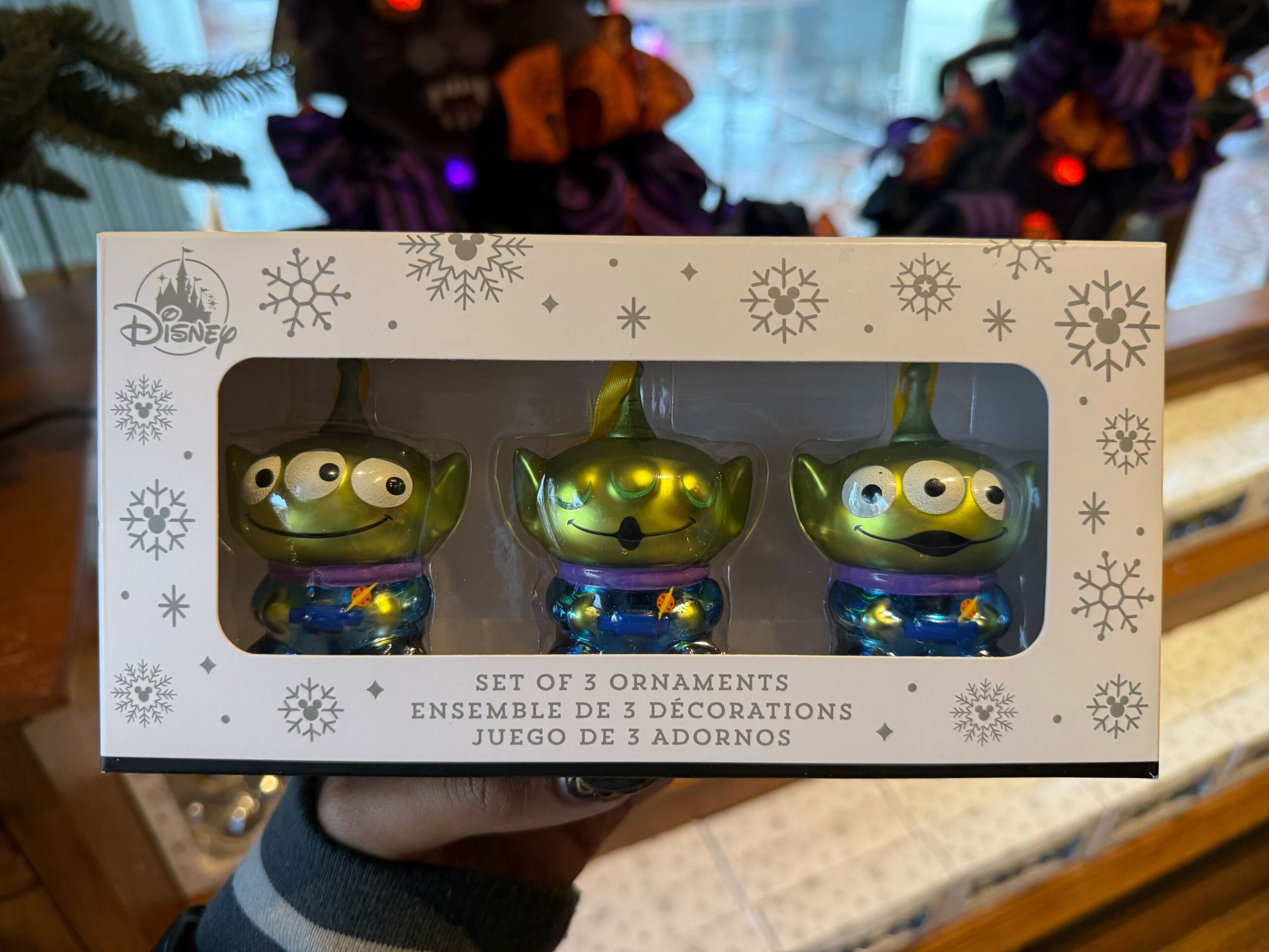 Set of three Disney green alien ornaments tangled in festive lights, featured in 2025 Disneyland Christmas Park merchandise.