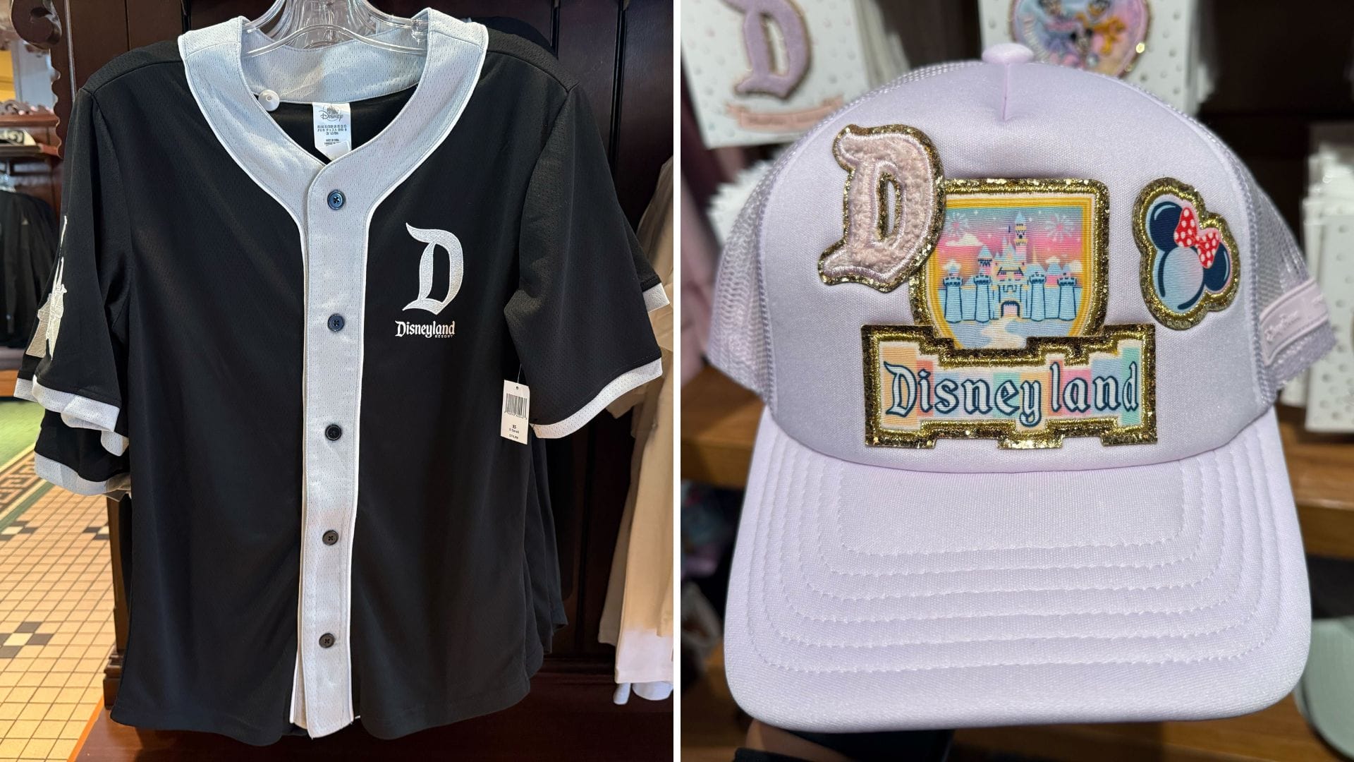 A black Disneyland baseball jersey and a lavender cap with castle patches, resembling Disneyland Park castles, are on display.