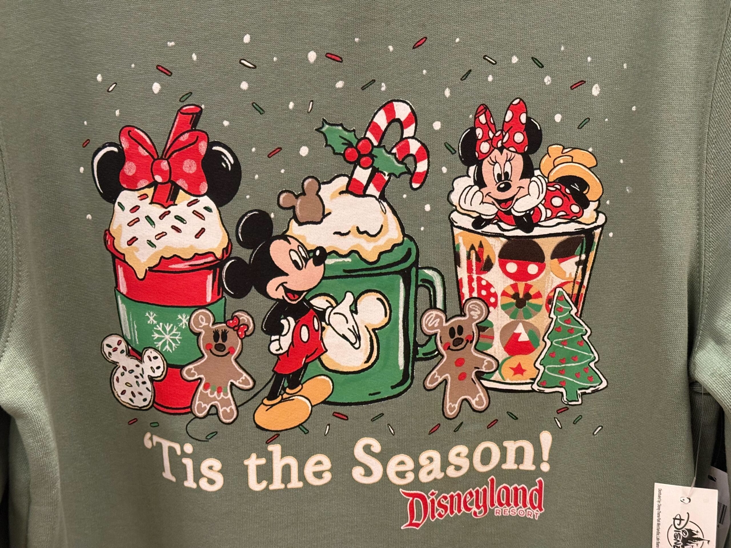 Mickey and Minnie Mouse with festive mugs, gingerbread cookies, and 2025 Disneyland holiday merchandise; no castle pictured.