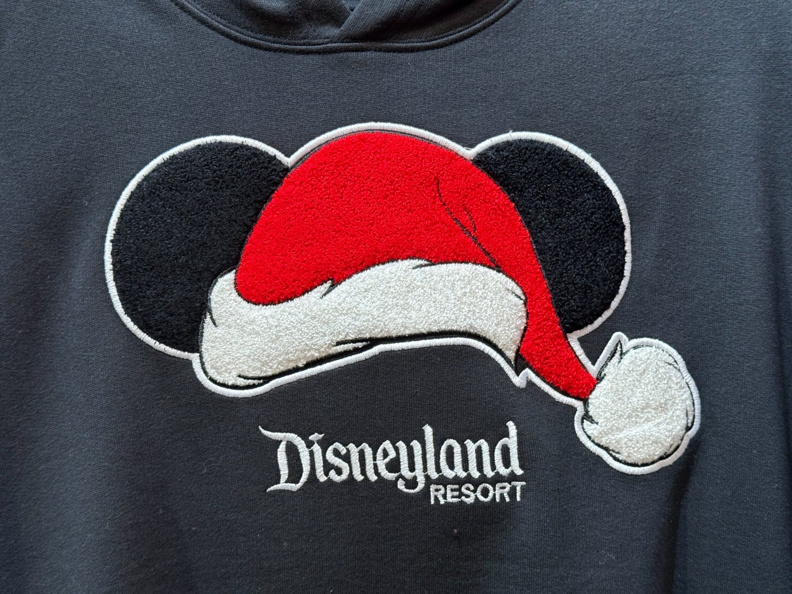 Festive Magic Key sweatshirt with Mickey ears wearing a Santa hat over "Disneyland Resort," showcasing classic Disneyland style.