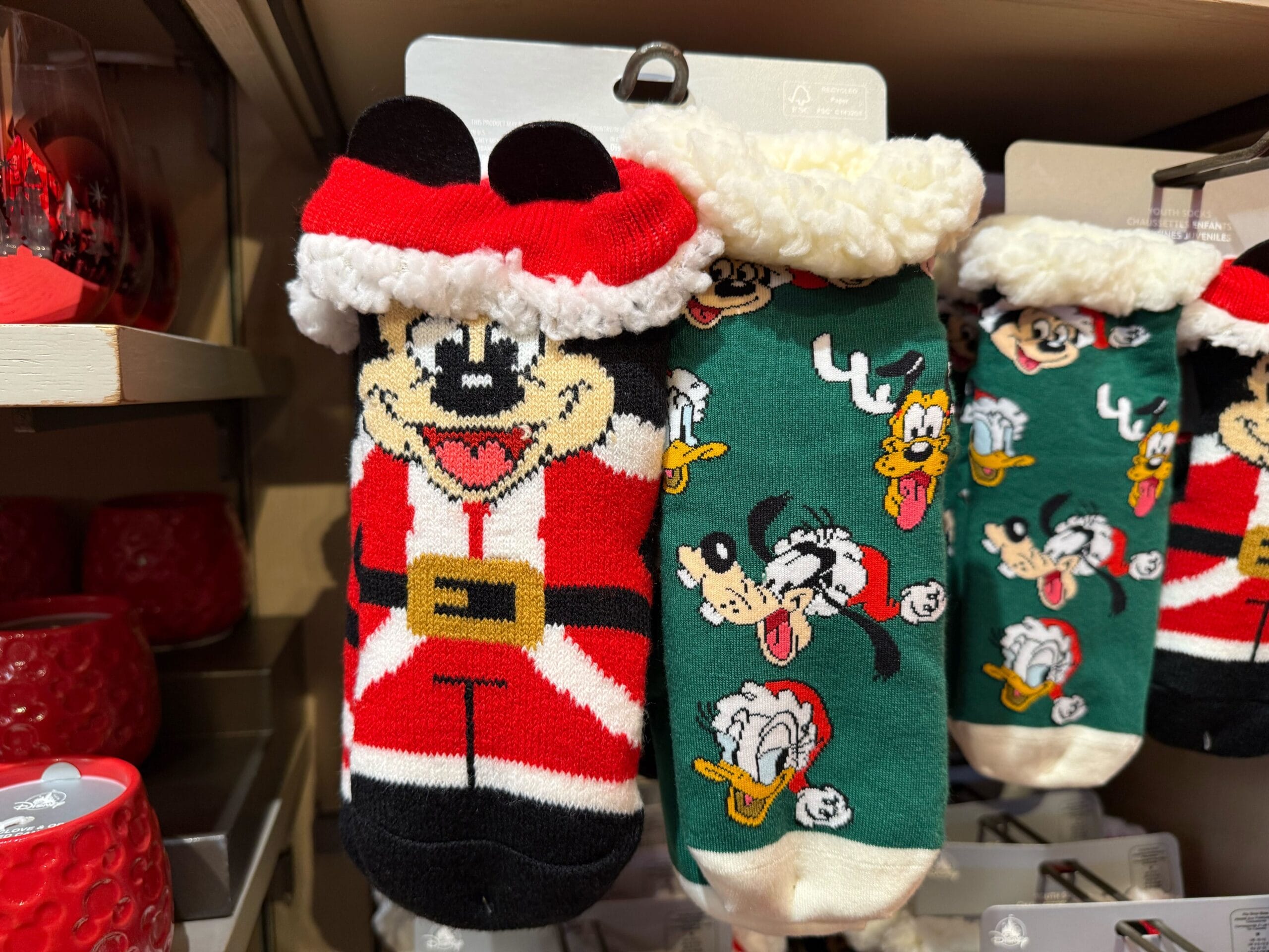 Two pairs of holiday-themed Disney socks from Disneyland’s Christmas collection, featuring Mickey & friends, exclusive to the park.
