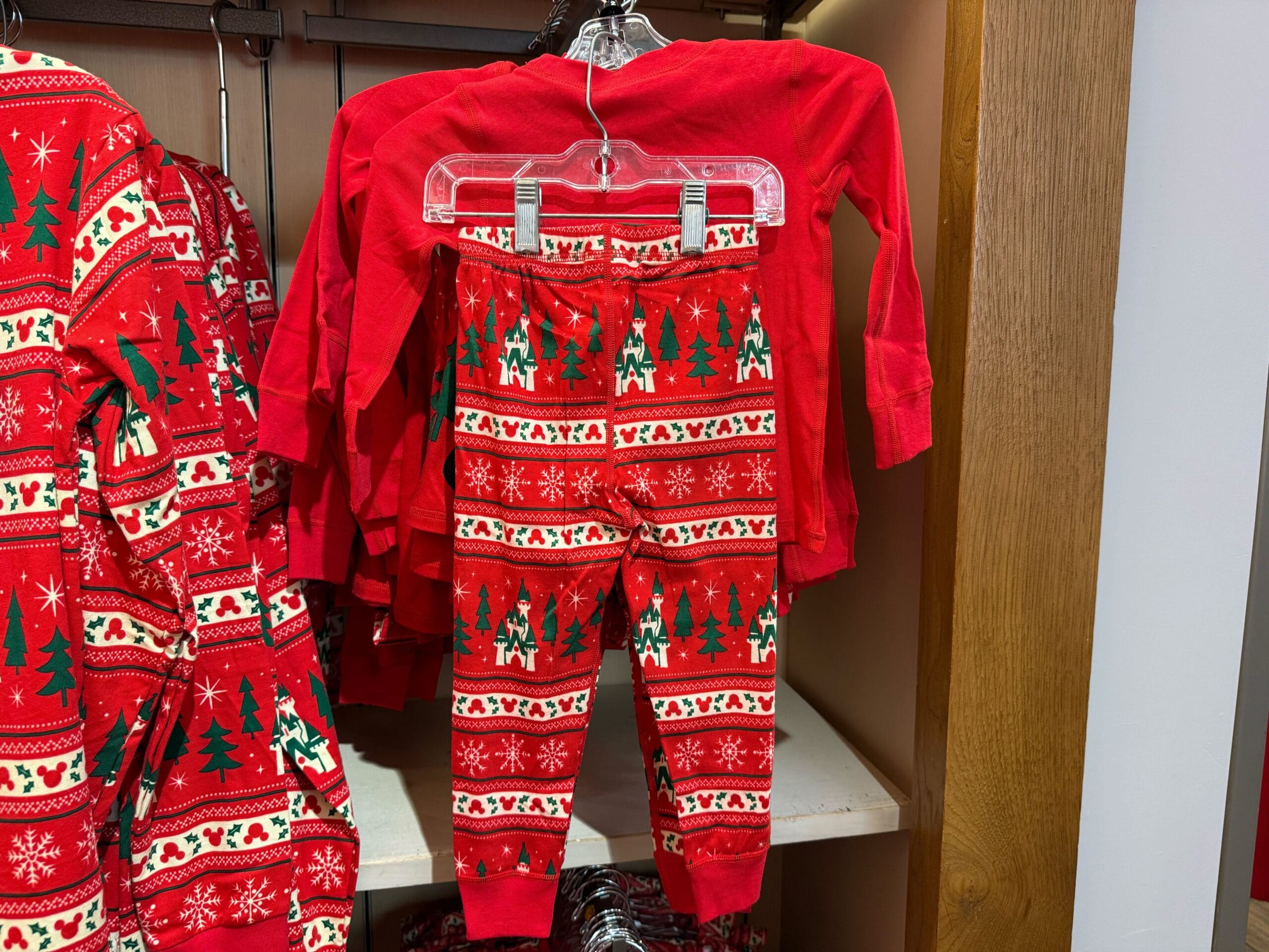 Red kids’ holiday pajamas from the Peppermint Collection, festive with Christmas icons—no Disney castle designs in this display.