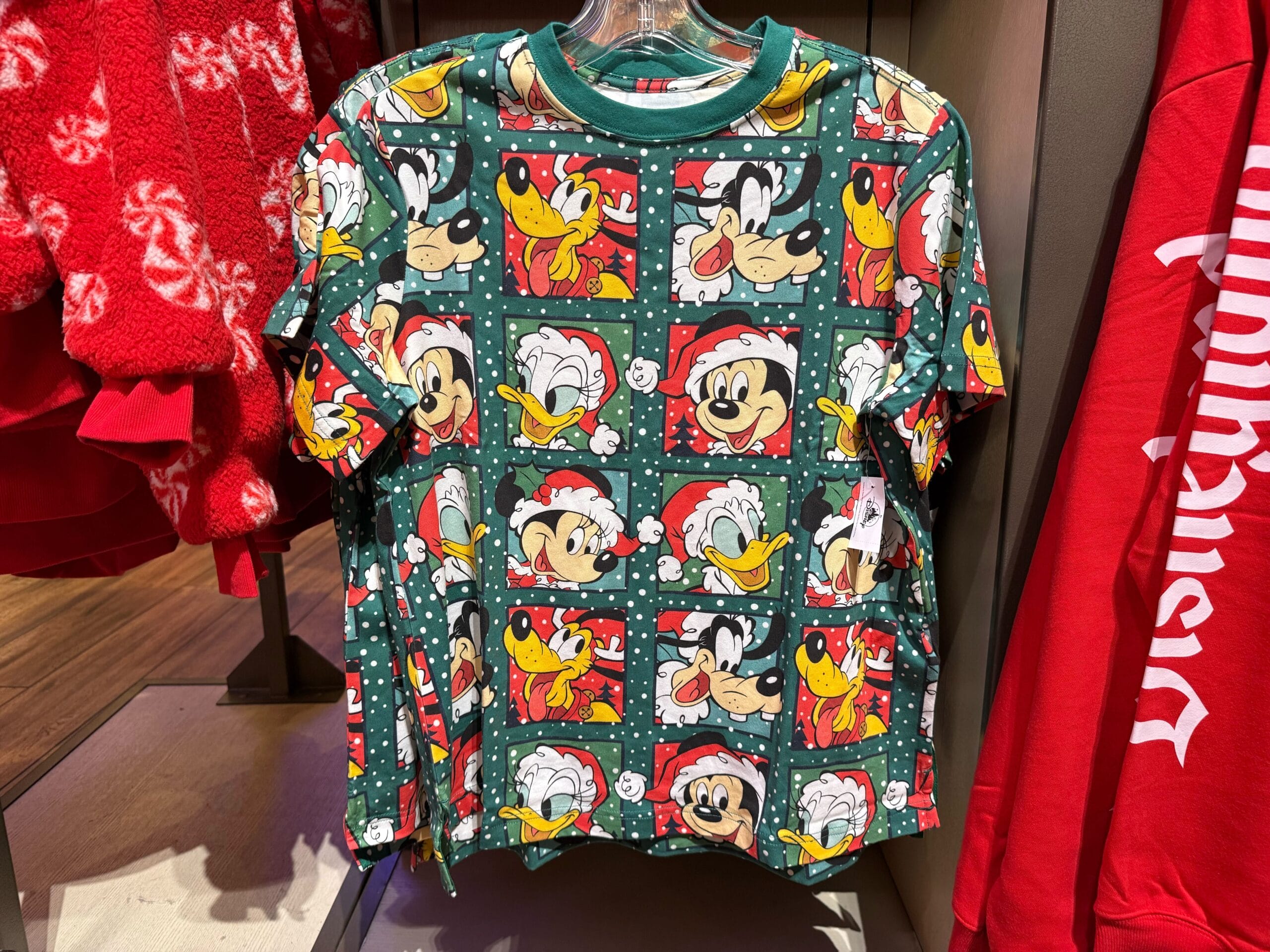 Festive green holiday shirt from Disneyland’s Christmas collection, featuring Mickey, Donald, Goofy & Pluto in Santa hats.