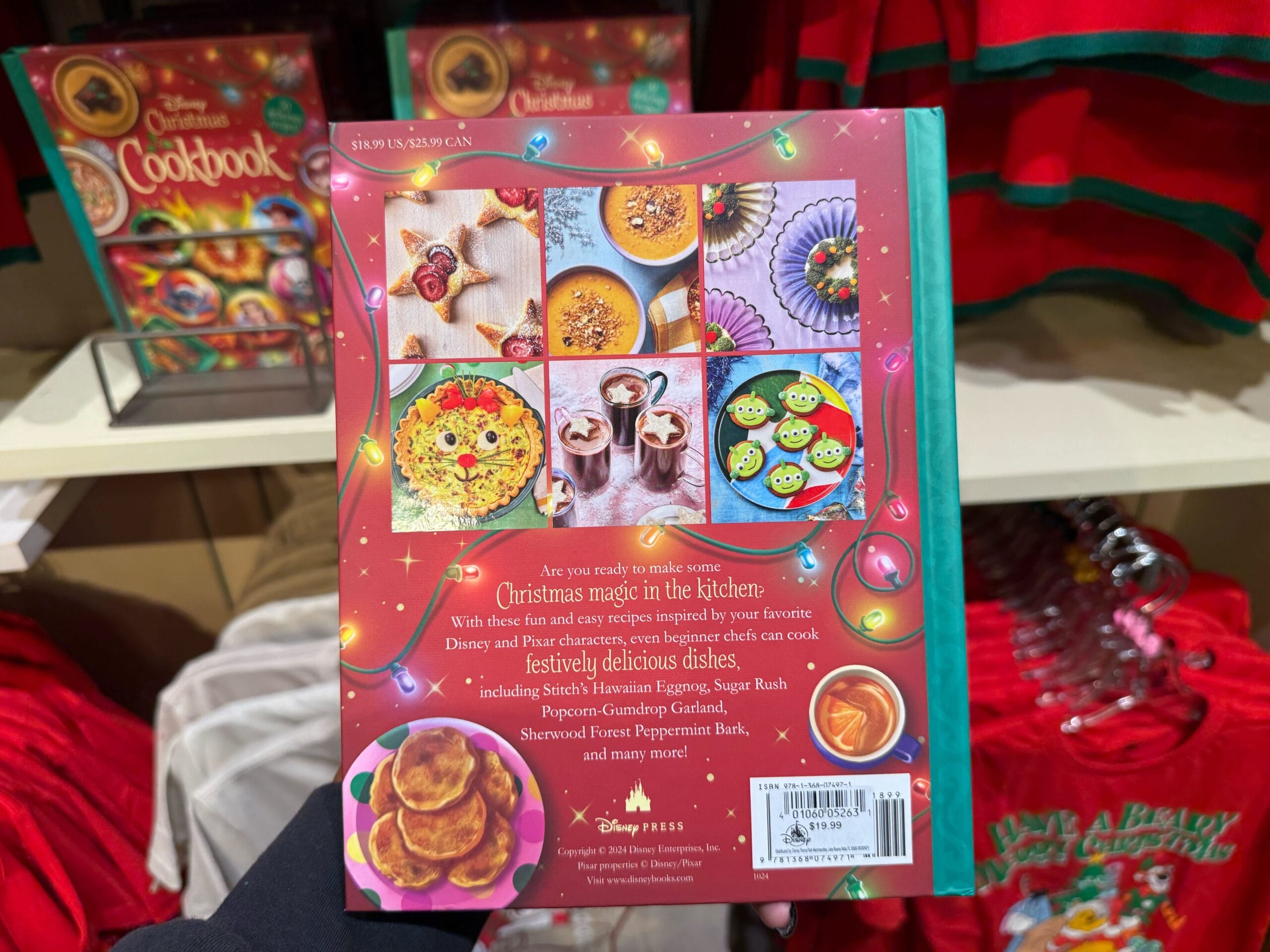 Back cover of a Disney cookbook with festive dishes, holiday decor, and Disneyland park Christmas merchandise on display.