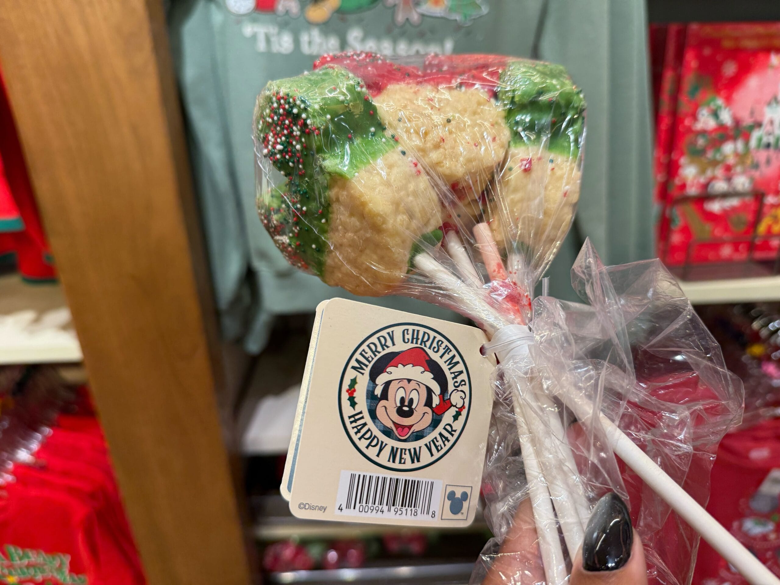 Three rice crispy treat pops with colorful sprinkles, a festive Disneyland treat—not pictured near any of the Disney park castles.