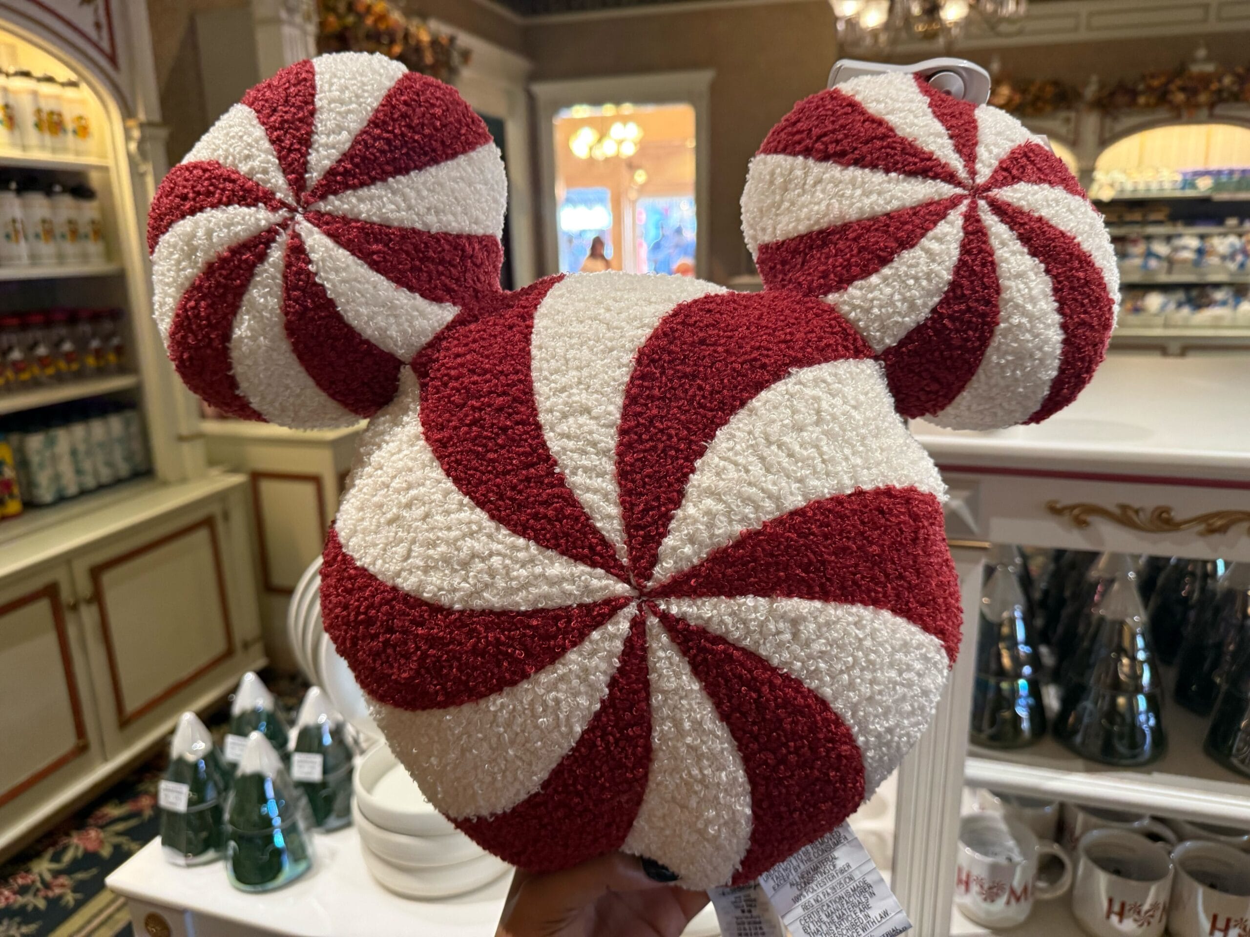 Peppermint-inspired red and white Mickey Mouse ears hat, a festive Christmas item at Disneyland Resort, not seen at Disney World.