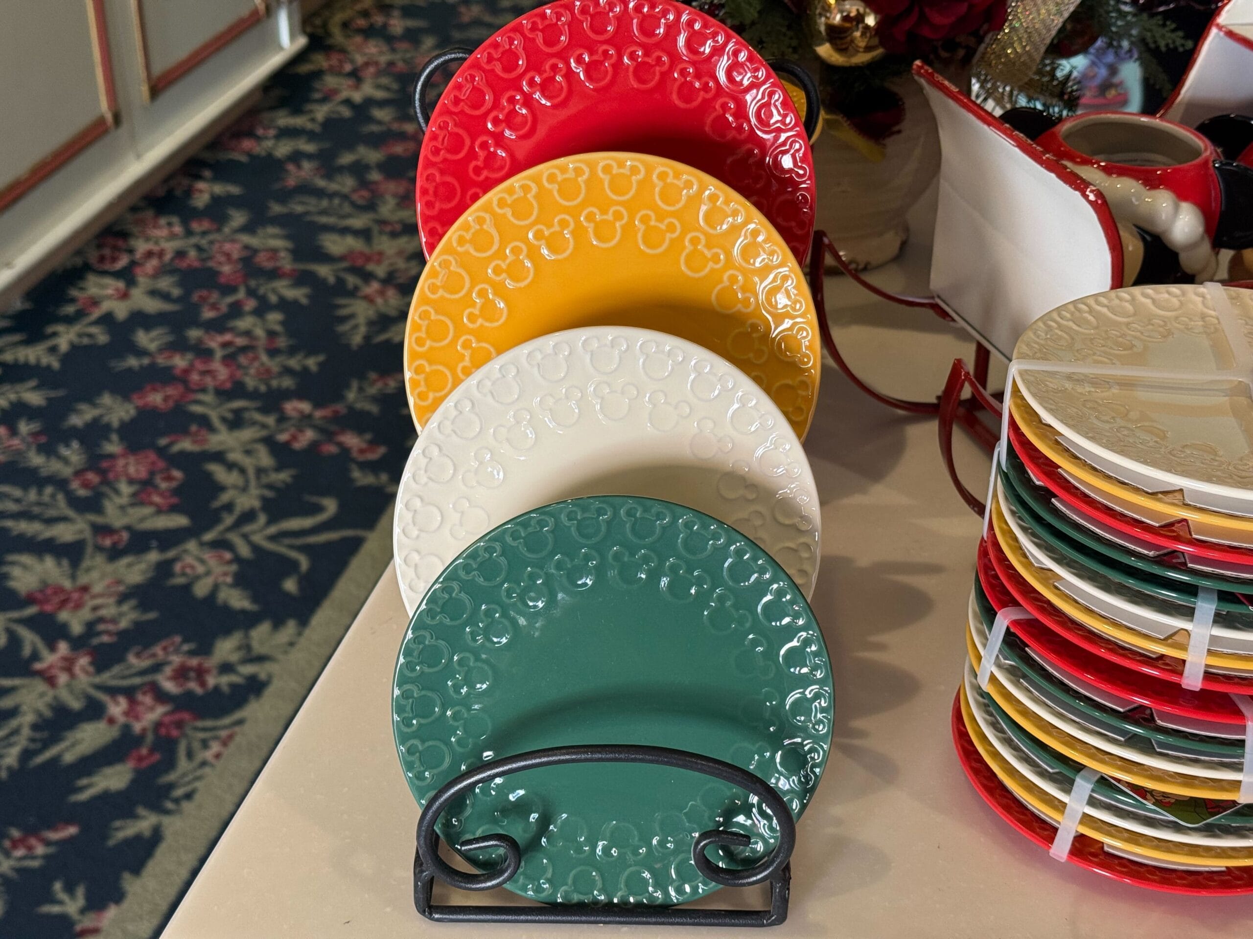 Four festive embossed Mickey Mouse plates, new to Disneyland Resort’s Christmas collection—no castle, but classic Disney cheer.