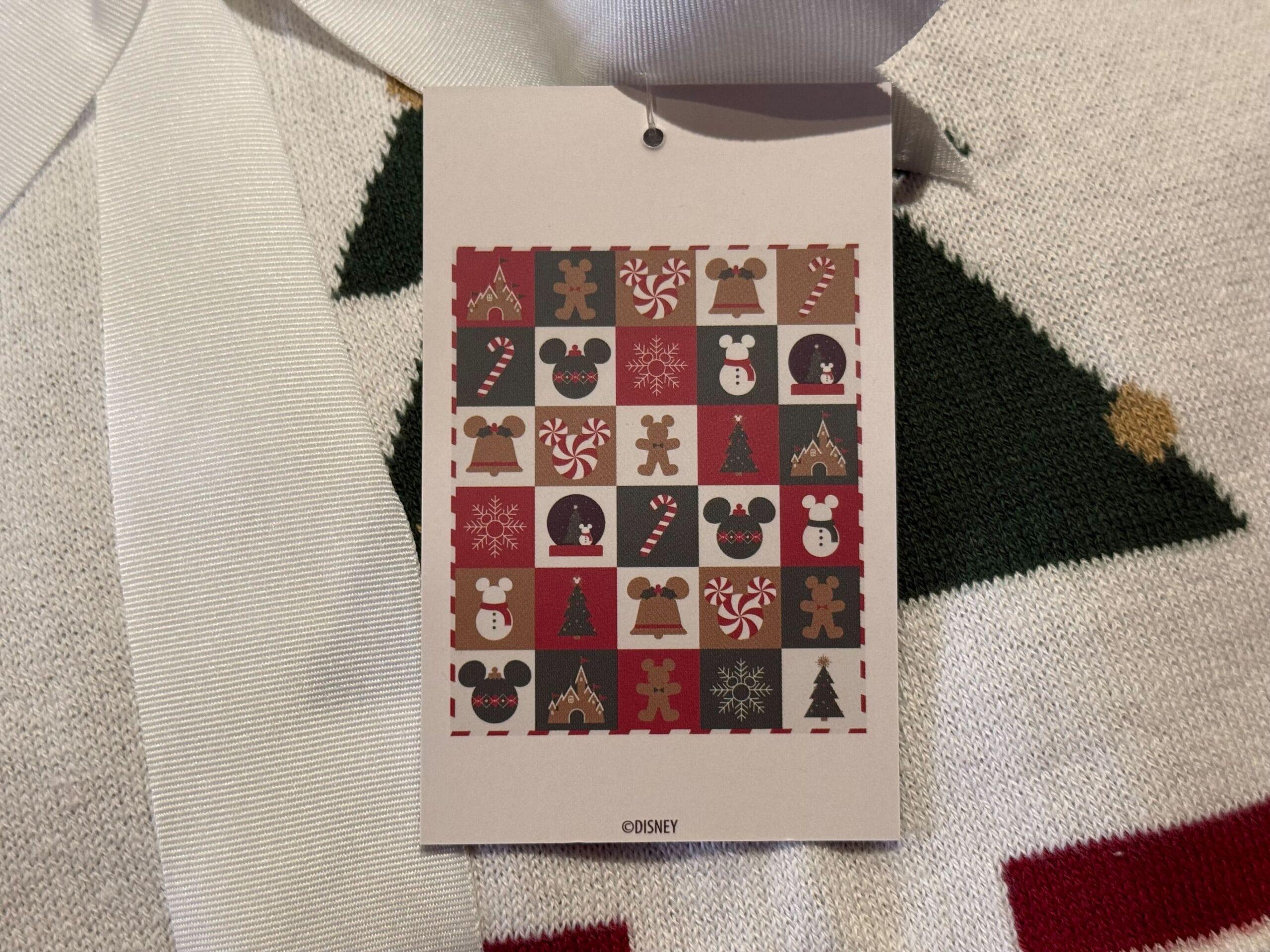 A Disneyland Resort tag with holiday Mickey ears, gingerbread men, and snowflakes—unique to this park's Christmas merchandise.