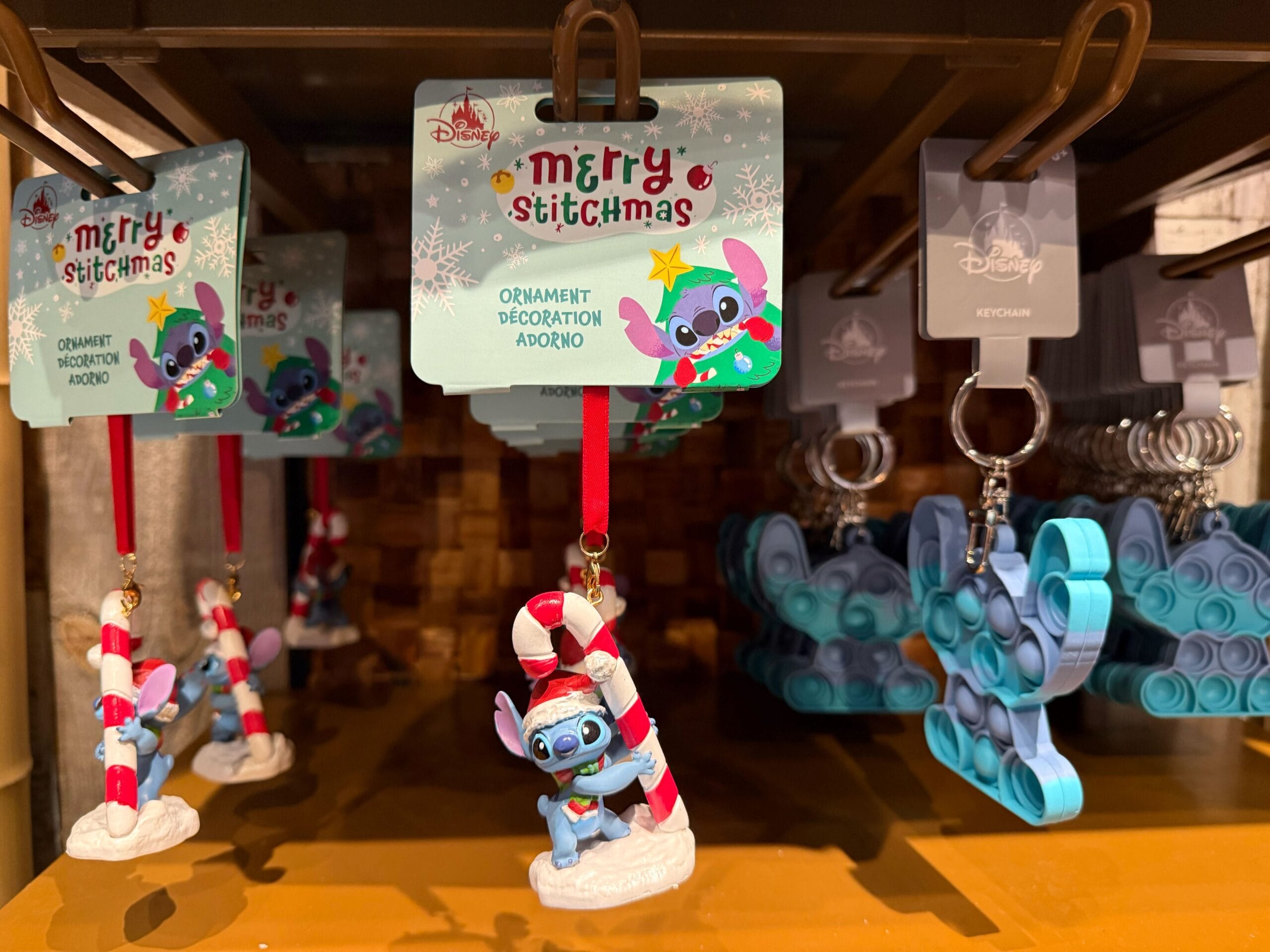Disneyland Resort Christmas: Stitch ornaments and keychains, new with festive candy cane accents—not Cinderella Castle in WDW.