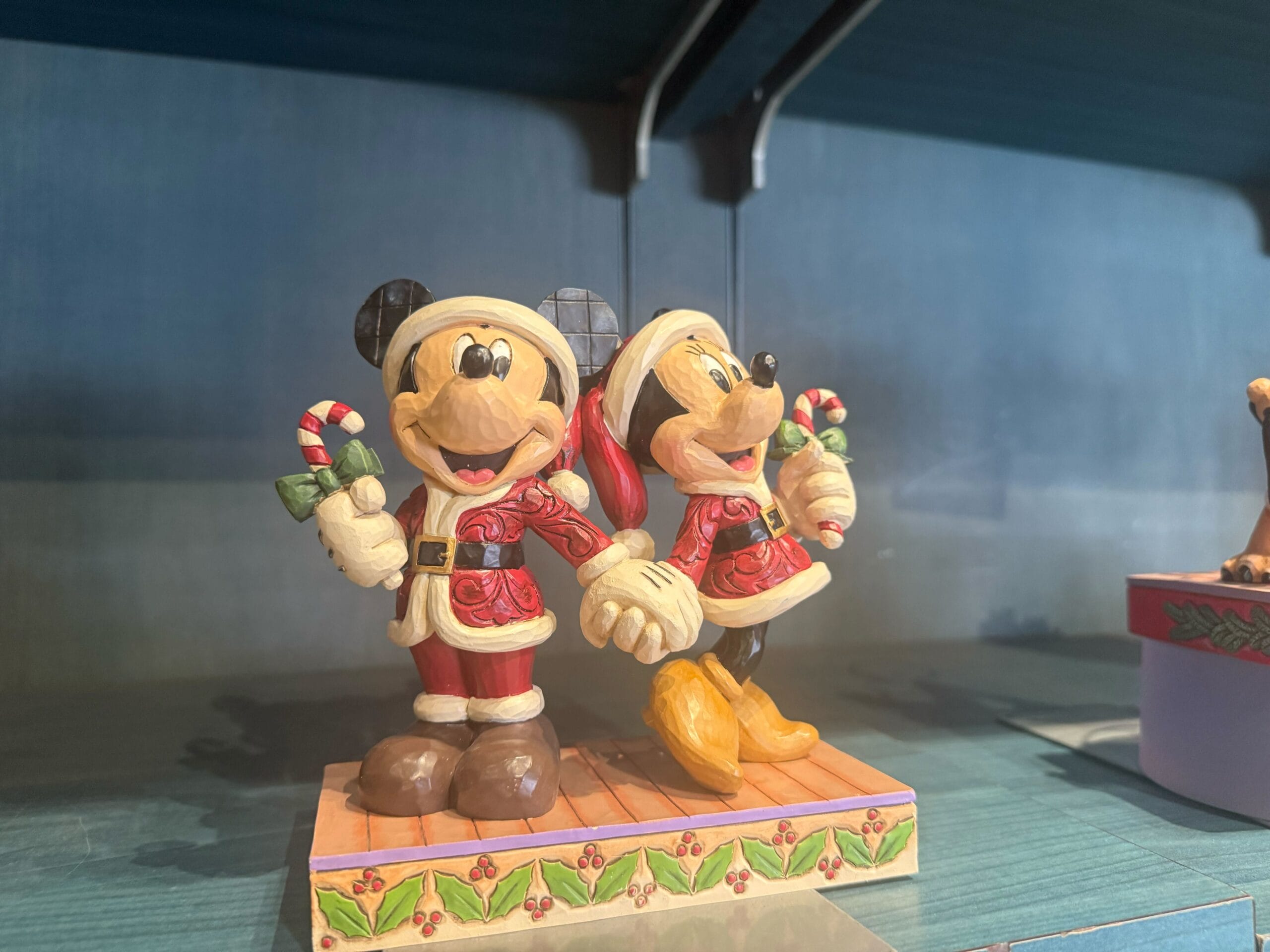 Mickey and Minnie Mouse in Christmas attire hold candy canes—festive Disneyland Resort merchandise with classic park charm.