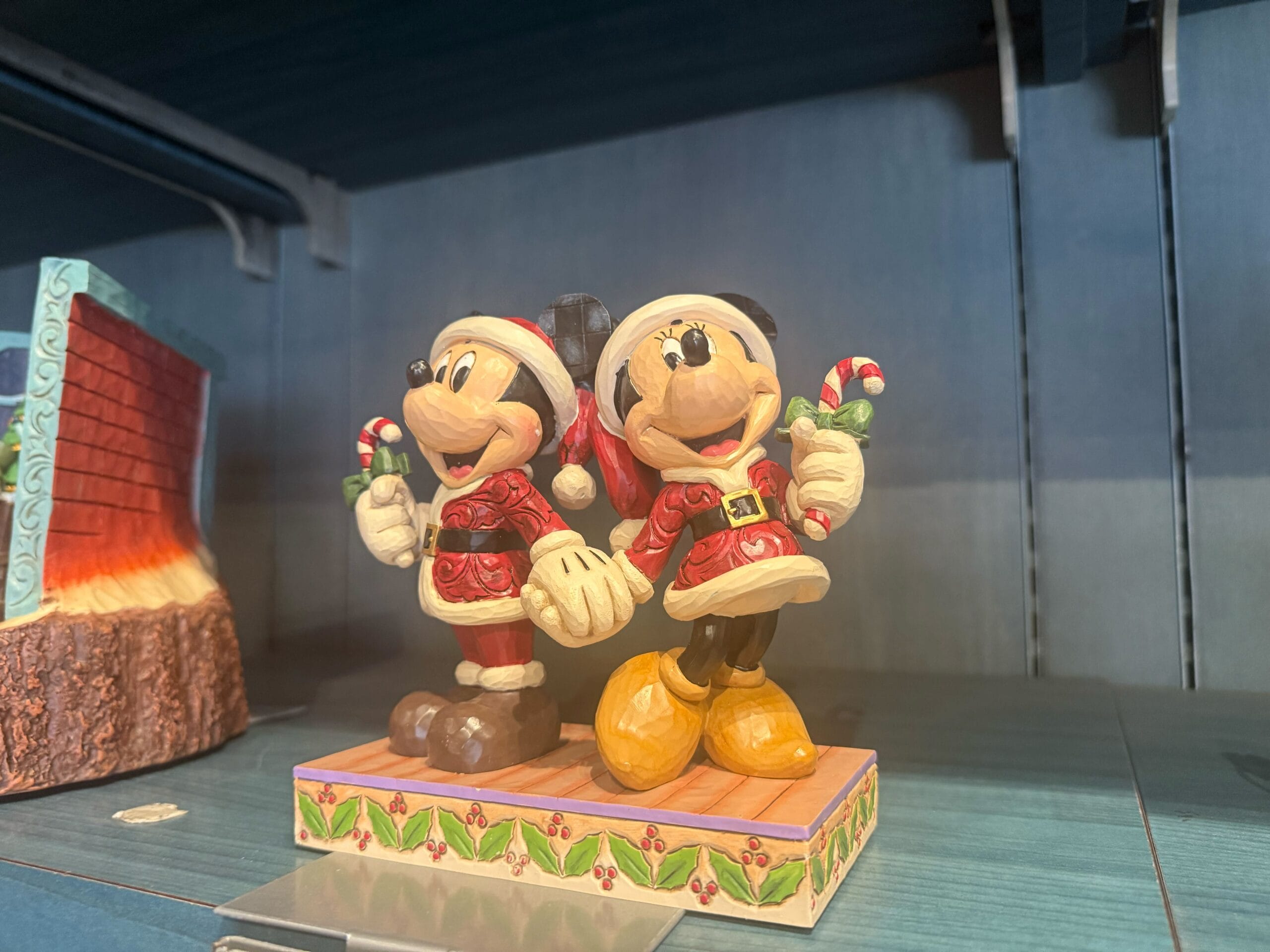 Mickey and Minnie Mouse Santa figurines holding candy canes—festive Disneyland Resort merch, like park-exclusive castle ornaments.