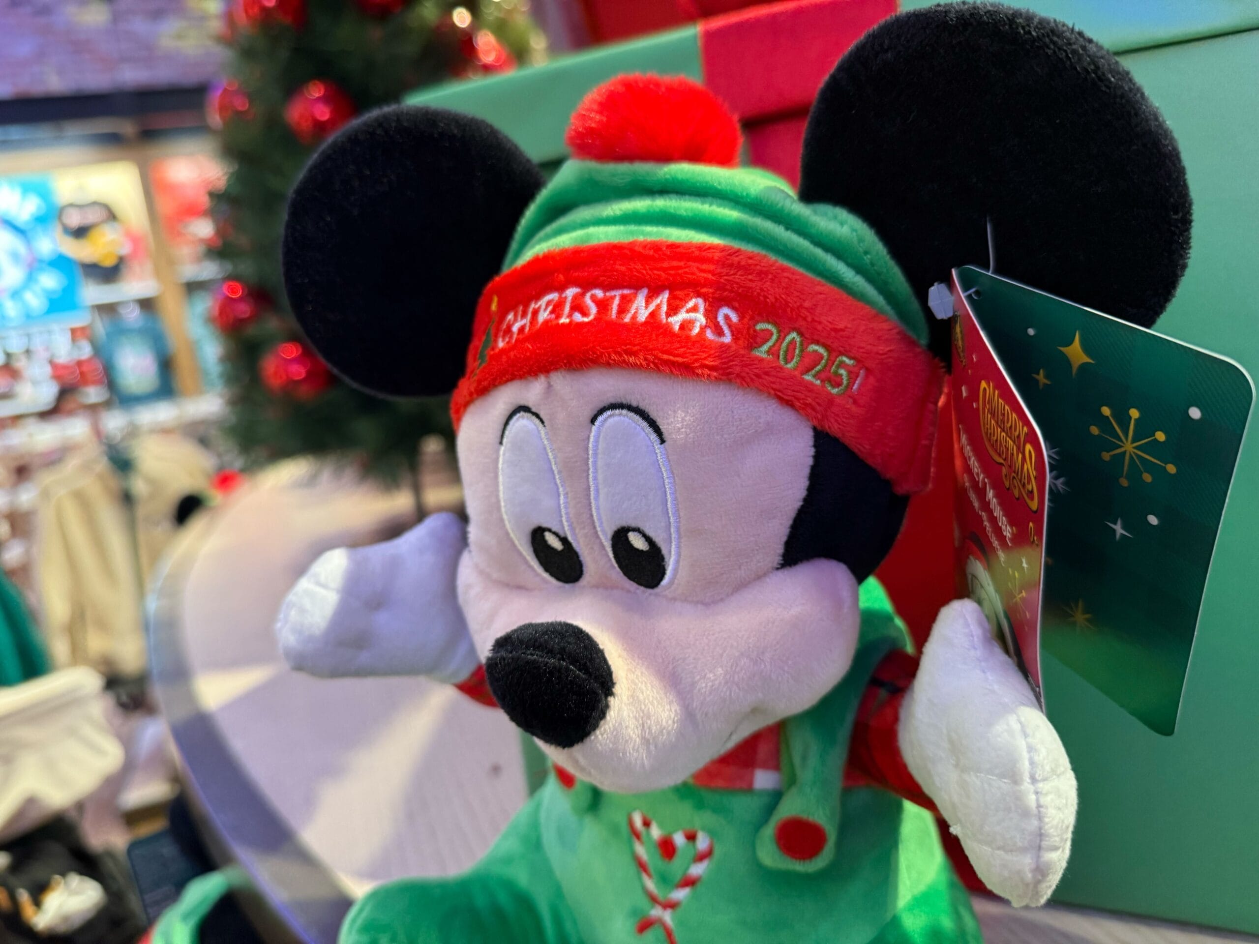 Plush toy in festive green and red "Christmas 2023" outfit, a Disneyland Resort exclusive—celebrating classic Disney holiday style.