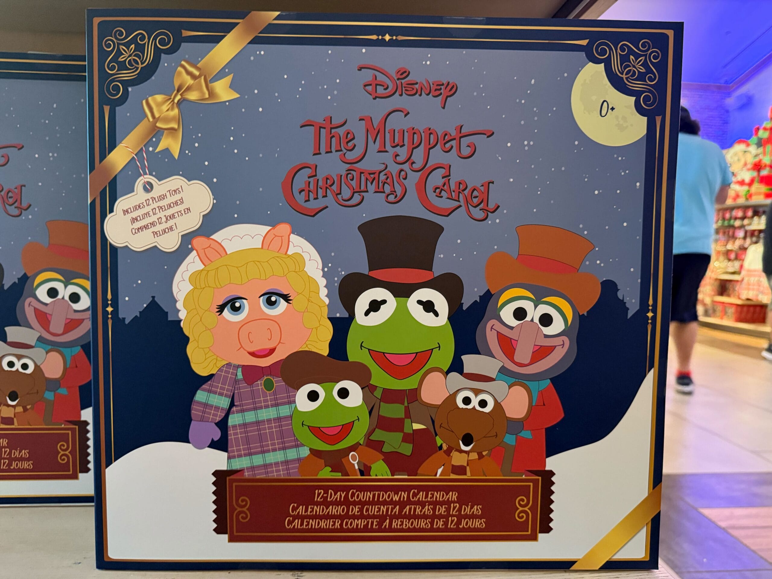 A box with Disney’s The Muppet Christmas Carol 12-day countdown calendar, festive new park merchandise—no castle shown to compare.
