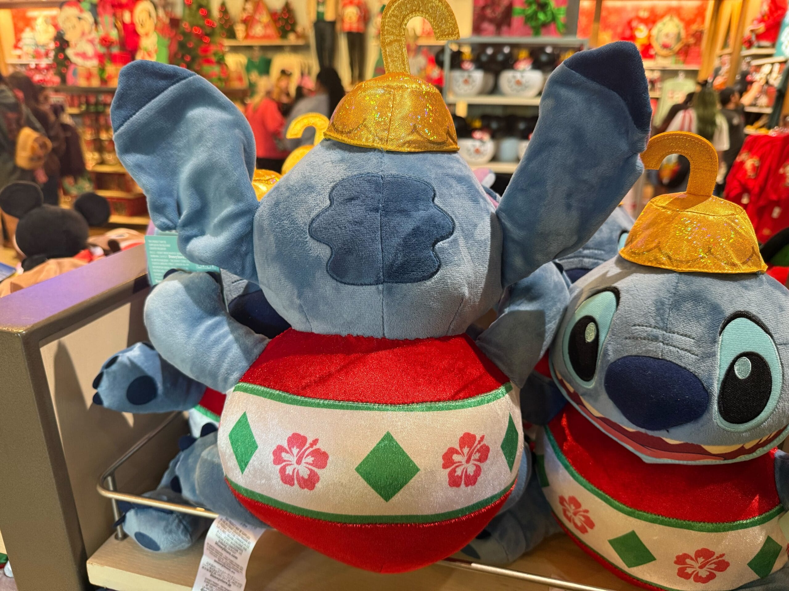 New Christmas merchandise at Disneyland Resort features plush Stitch toys dressed as festive ornaments, unique to Disneyland US.