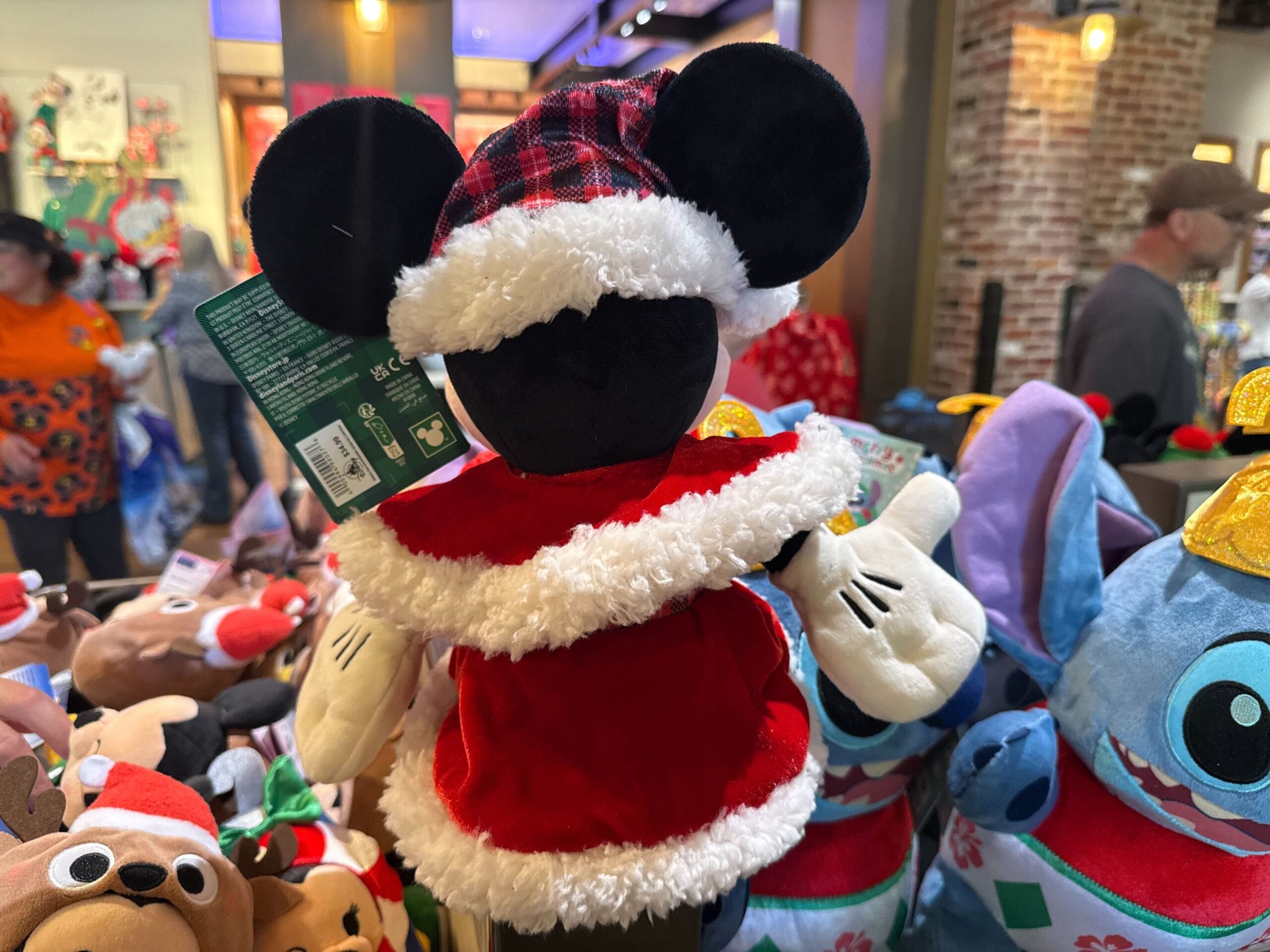 Plush Mickey Mouse toy dressed as Santa, featured in Disneyland Resort’s festive holiday merchandise display—classic US Disney style.