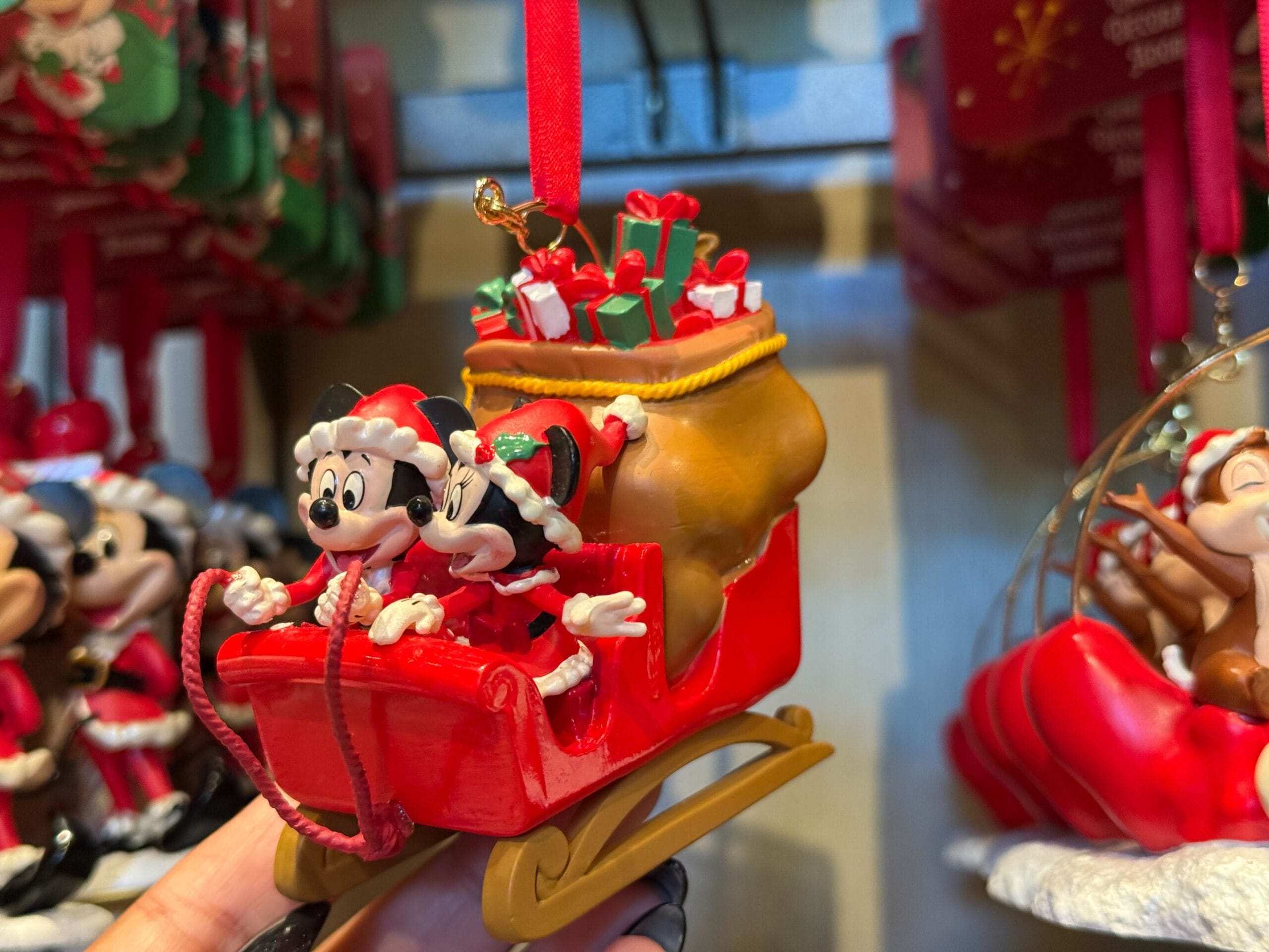 Mickey and Minnie as Santa ride a sleigh packed with gifts, held in hand—ideal for fans of Disney parks like Disneyland Resort.
