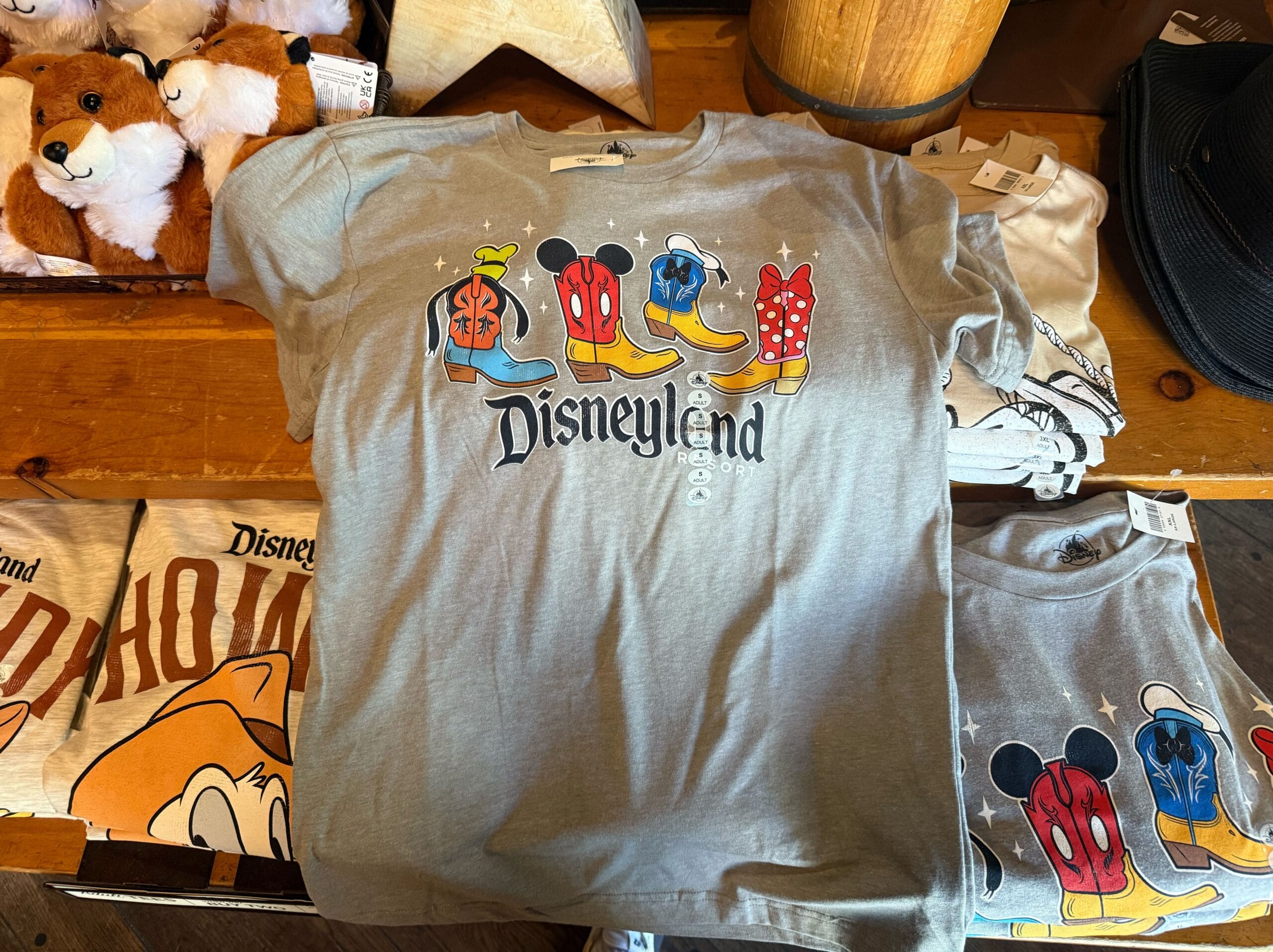 Gray Disneyland t-shirt with "LUCKY" in Disney character shoes and hats, perfect for fans of Logo Sweatshirts.