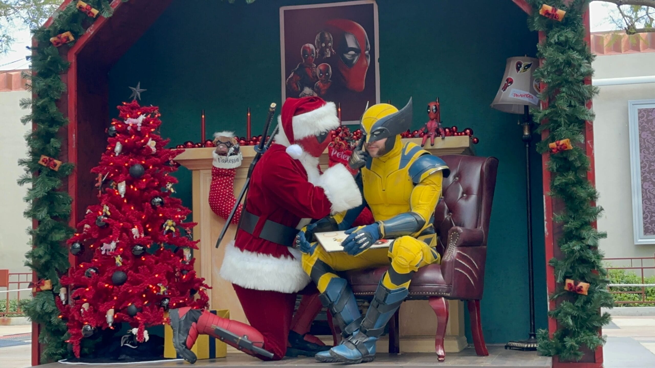 Santa Claus kneels by Wolverine in a festively decorated Christmas room, reminiscent of Disney Parks’ holiday decor magic.