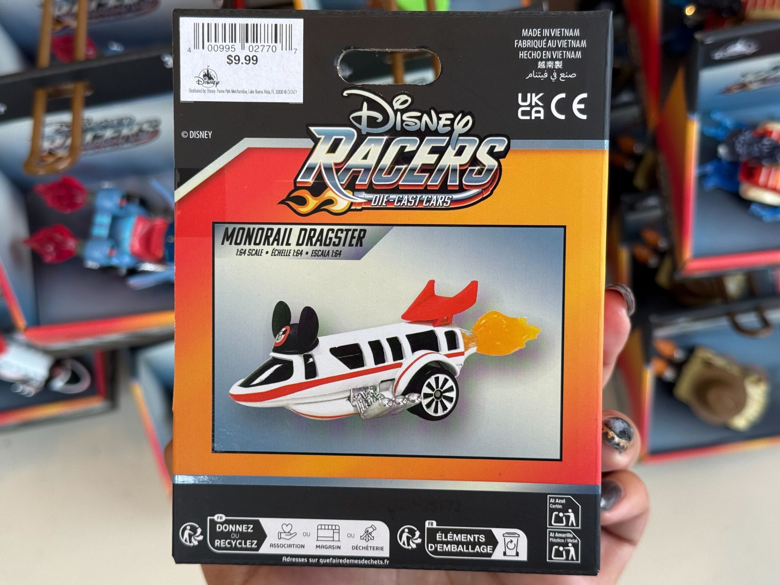 Disneyland Disney Racers Monorail Dragster toy, packaged, showcases a sleek white car with flame exhaust—classic park souvenir.