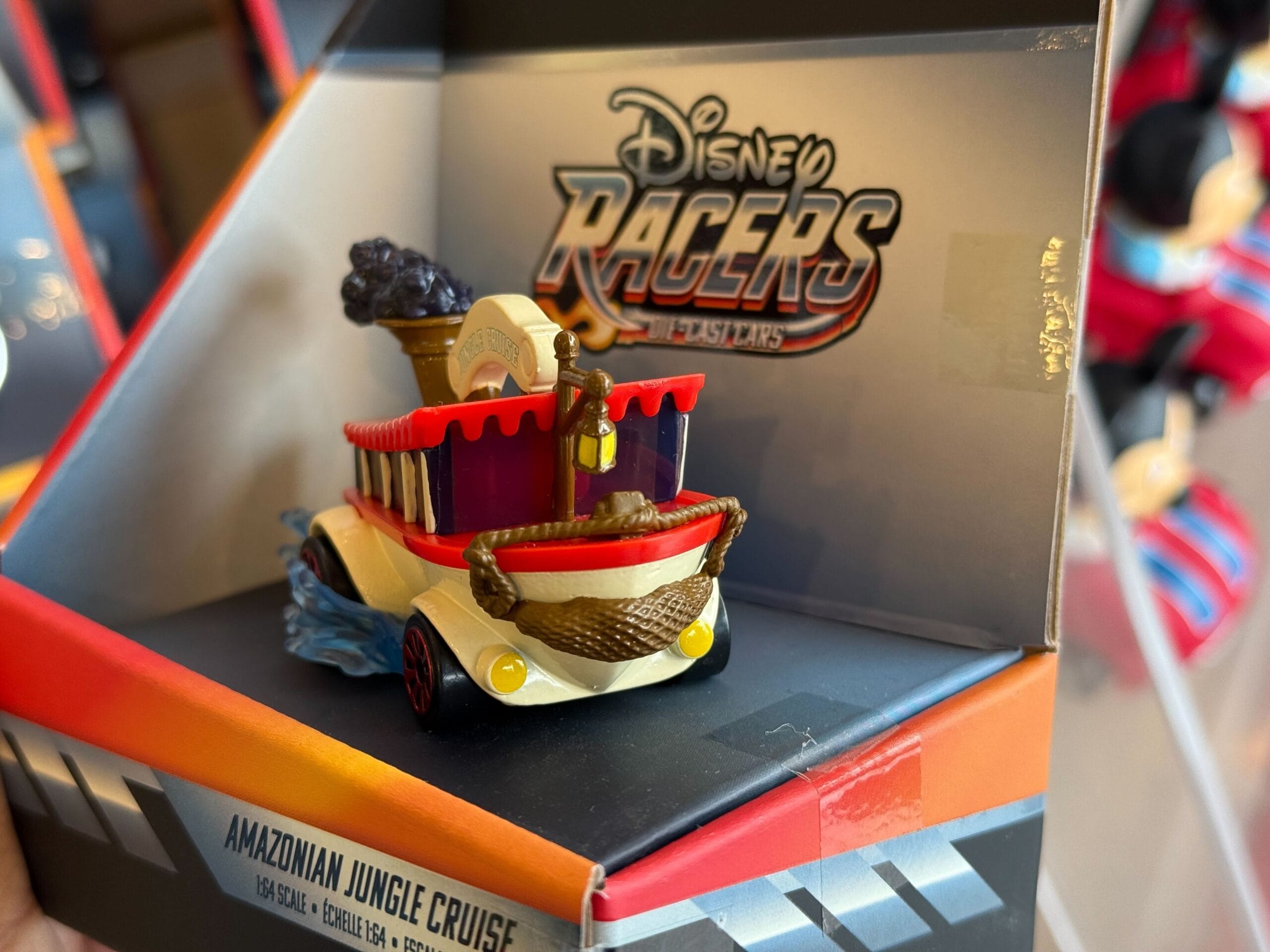 A Disney Racers Amazonian Jungle Cruise toy boat in Disneyland-themed packaging, styled after classic park attractions, no castle shown.