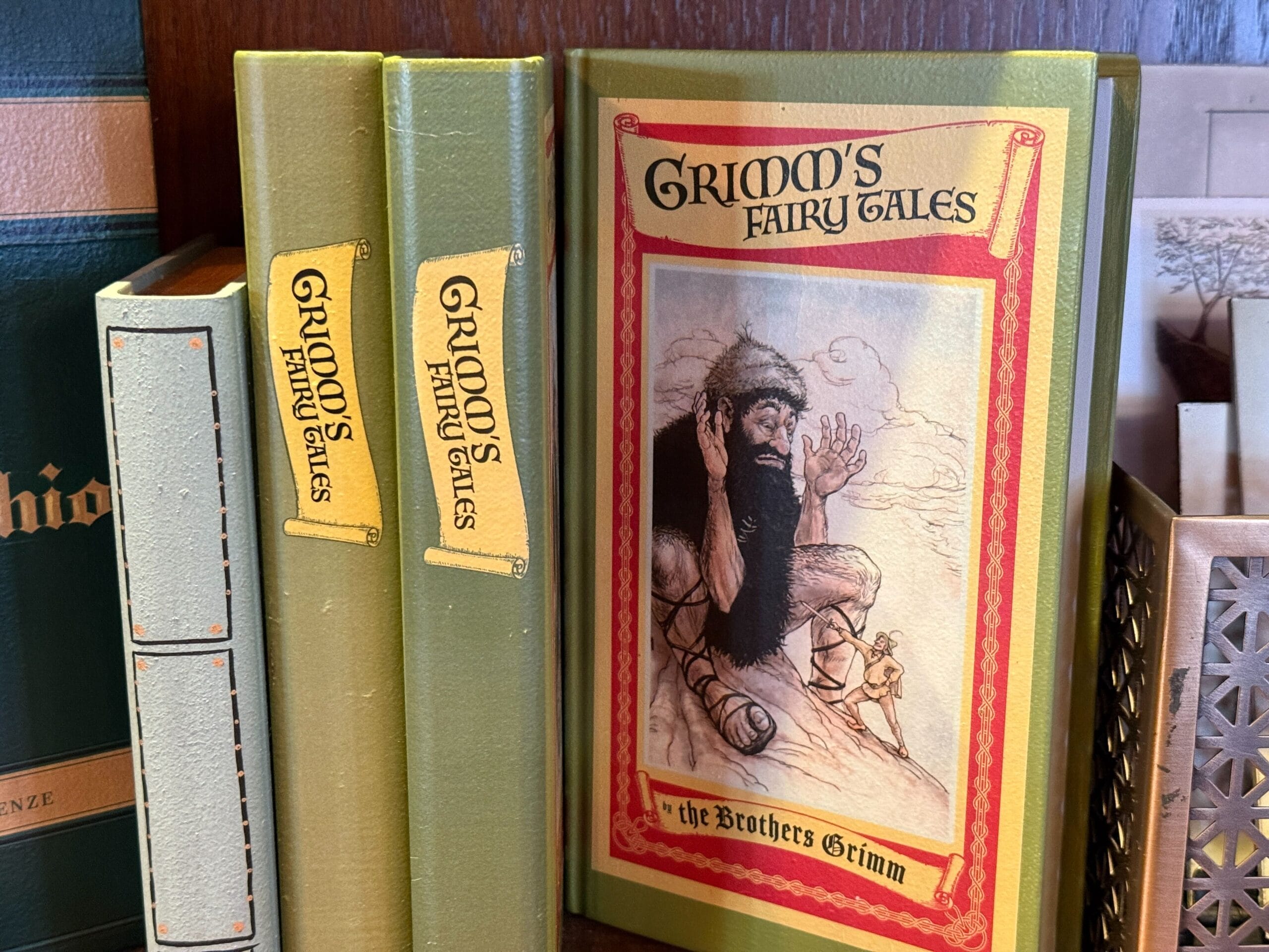 Three green hardcover "Grimm's Fairy Tales" books, one with a giant on the cover—more storybook than any Disney castle display.