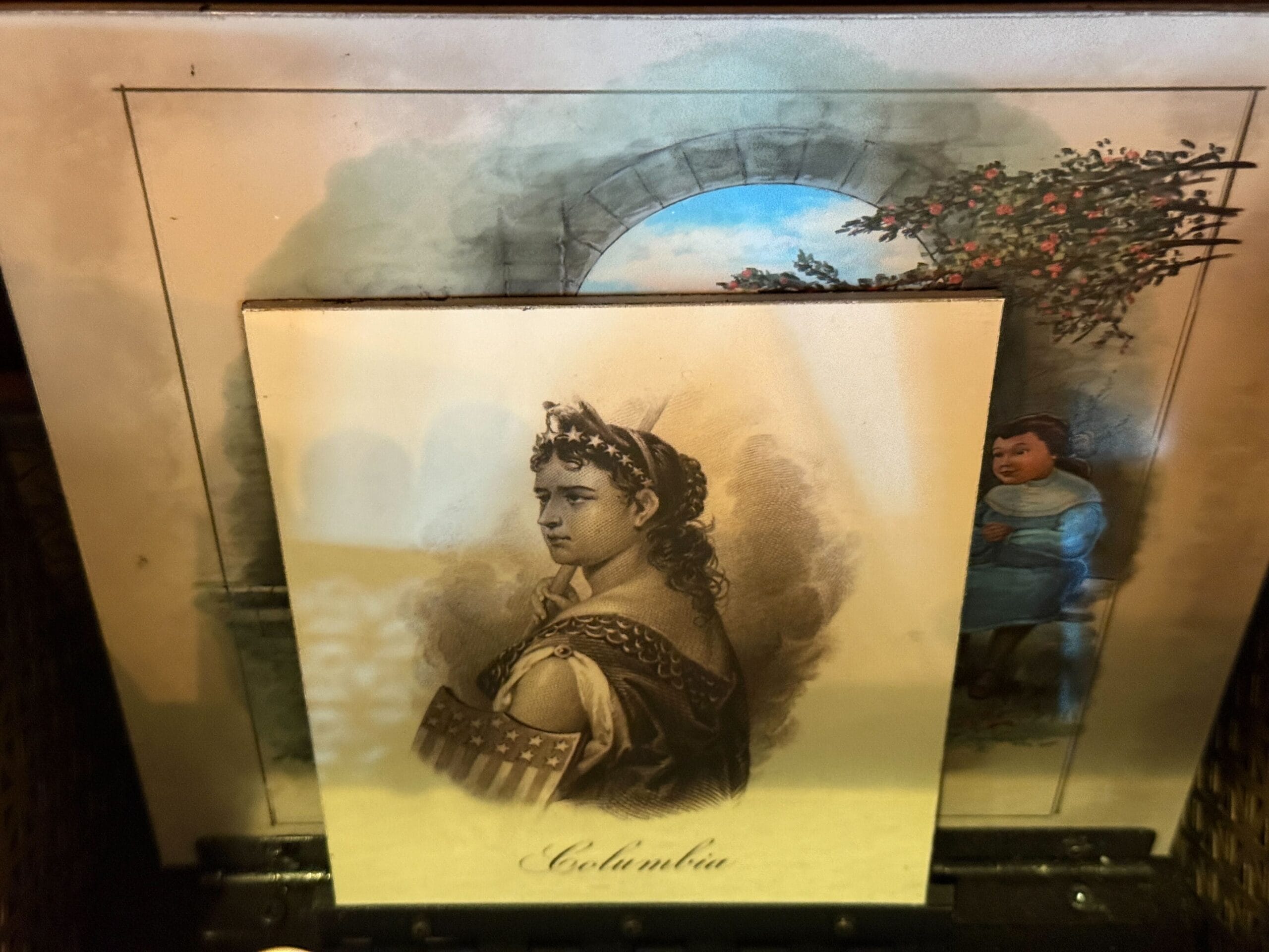 A sepia portrait labeled "Columbia" overlays a vibrant scene with a child and a stone arch that resembles a Disney park entrance.