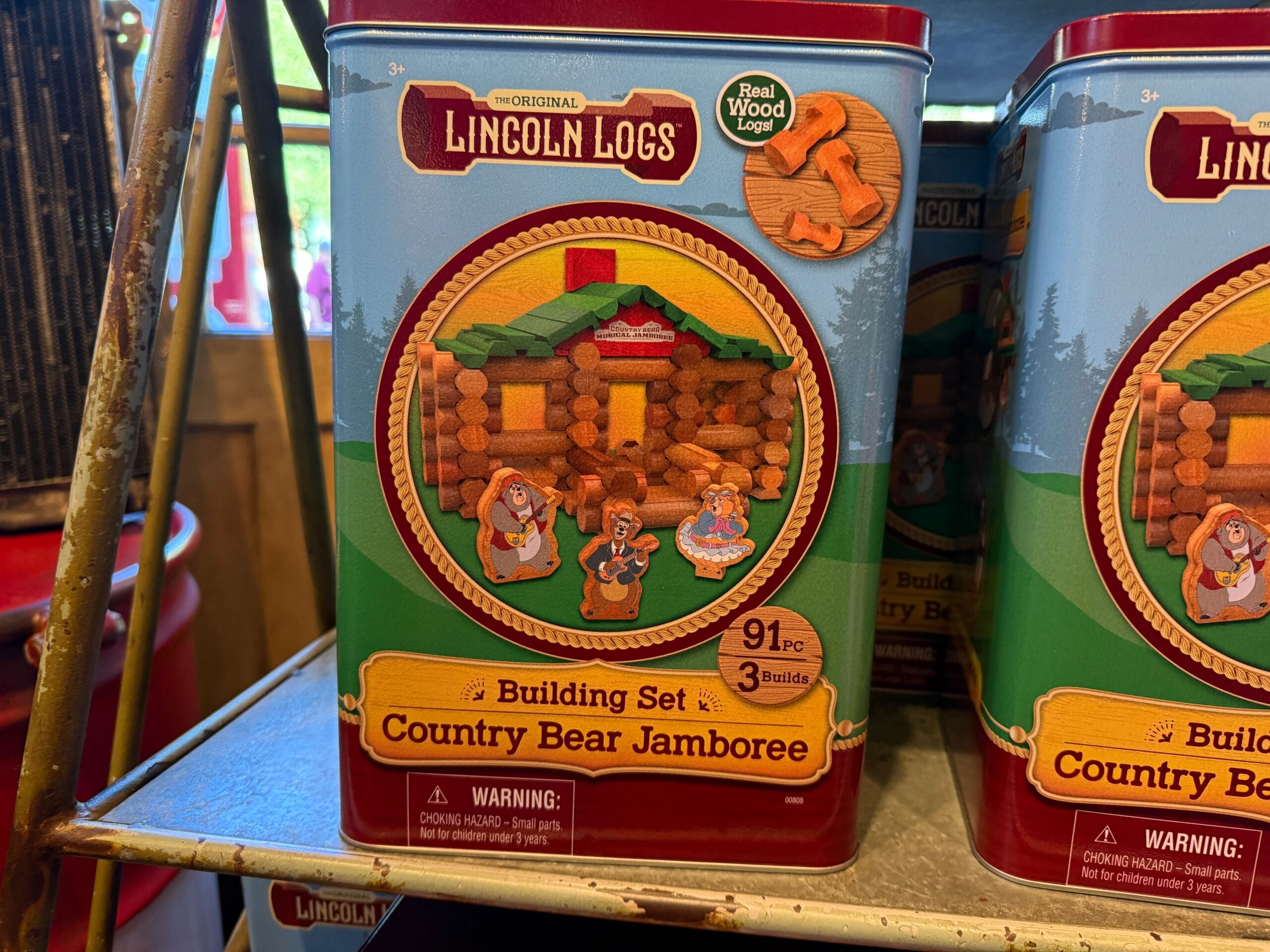 Lincoln Logs Country Bear Jamboree set tin features Country Bears and a log cabin, just like Frontierland adventures.