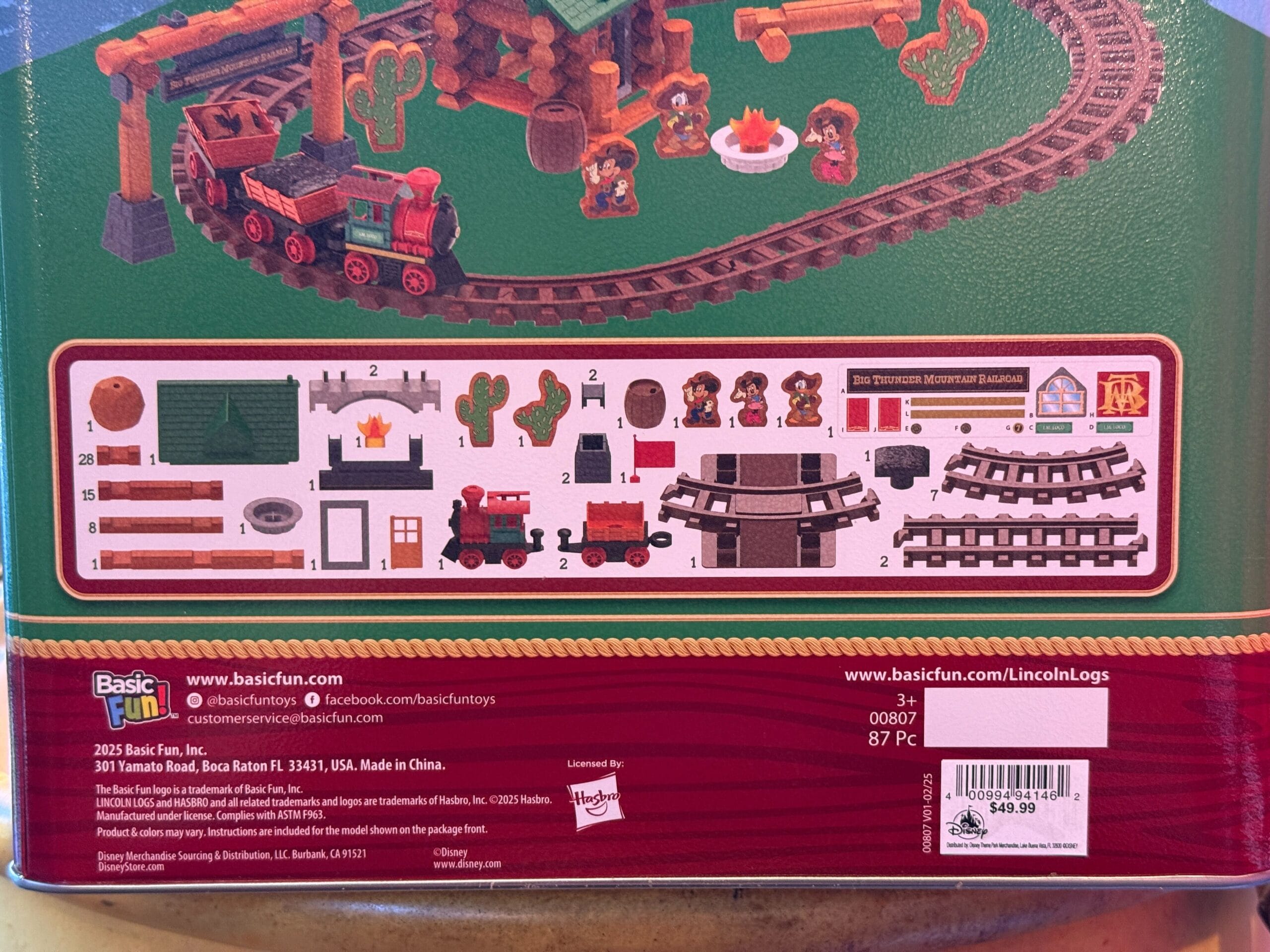 Back of a toy train set box featuring Frontierland pieces, assembly steps, and $69.99 Disneyland price tag.