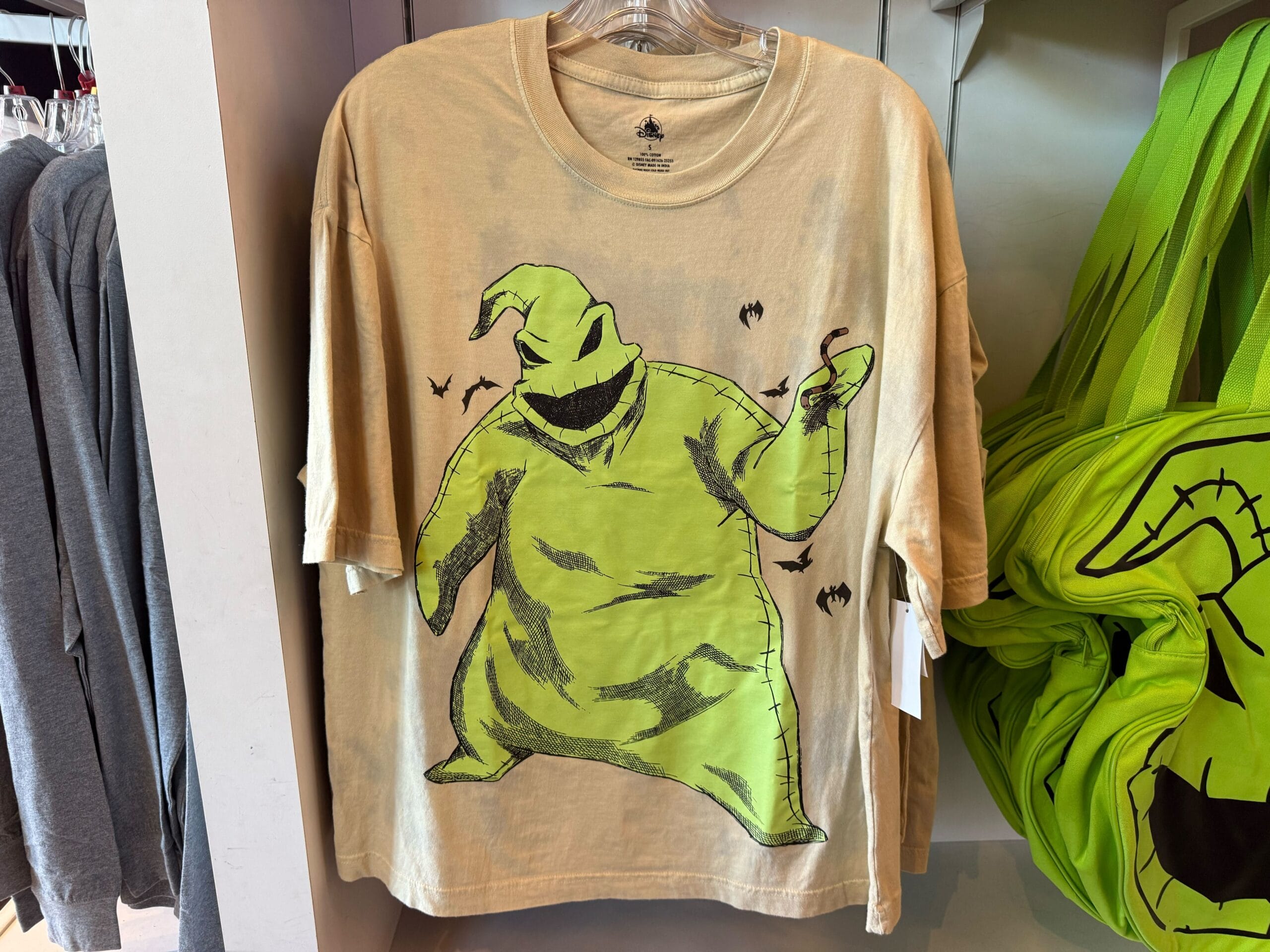Beige T-shirt with Oogie Boogie and bats, inspired by "The Nightmare Before Christmas" at Disney Parks—no castle shown.