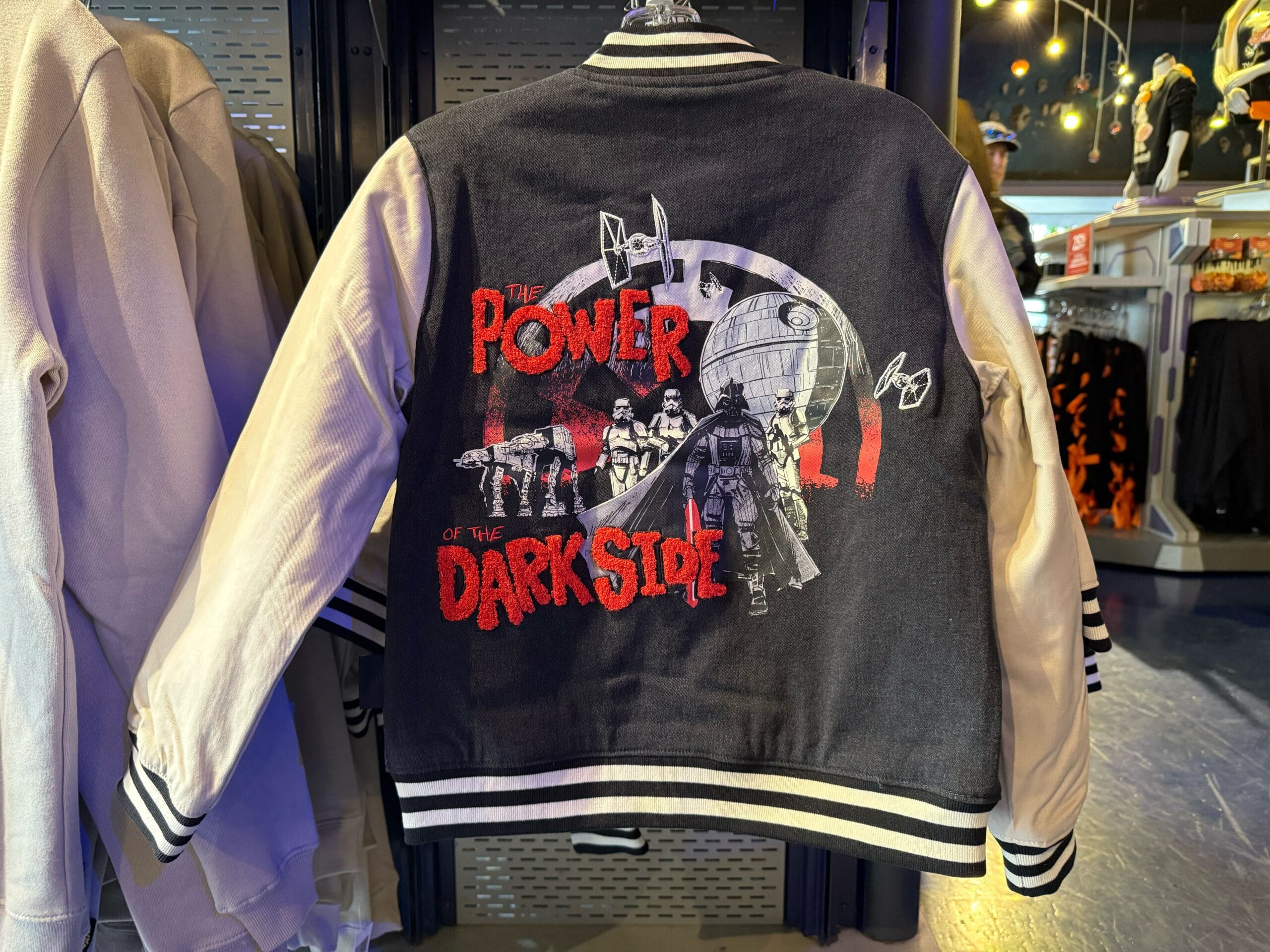 Black and white varsity jacket featuring Star Wars villains and "The Power of the Dark Side" on the back, spotted at Disneyland.