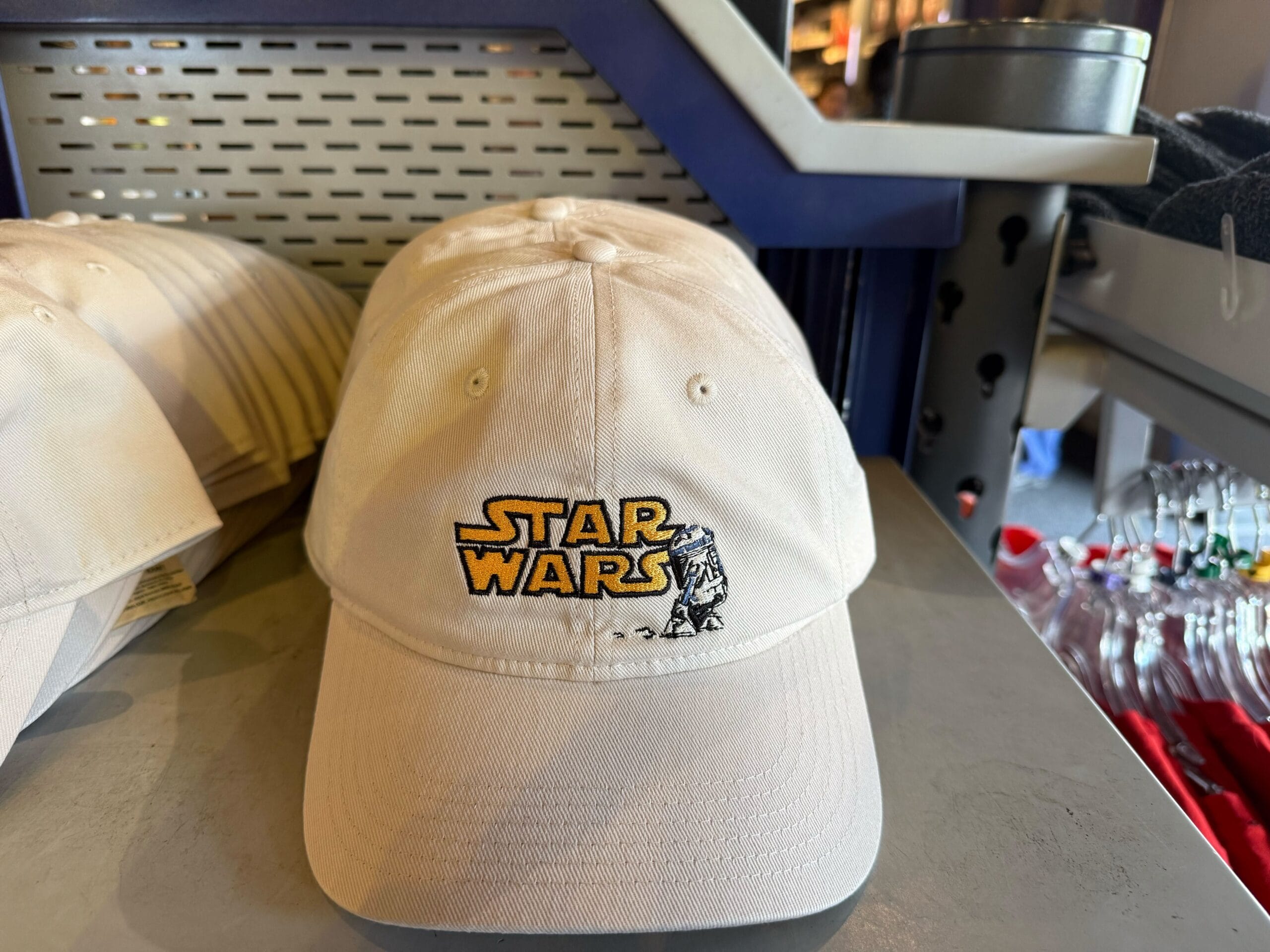 A beige Star Wars hat with Yoda by the logo, a fun Disney Parks souvenir for fans—just like finding Yoda near Cinderella Castle.