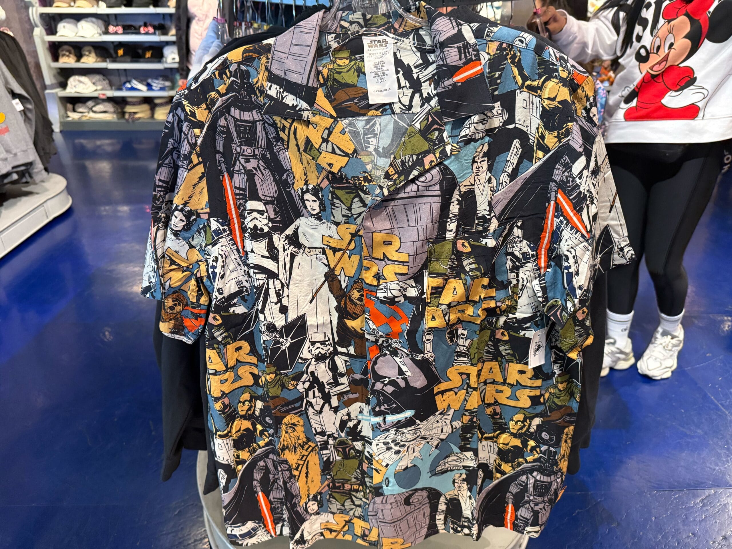 Star Wars short-sleeve button-up with comic Darth Vader and Boba Fett, showcased in a Disney Park shop, not near a castle.