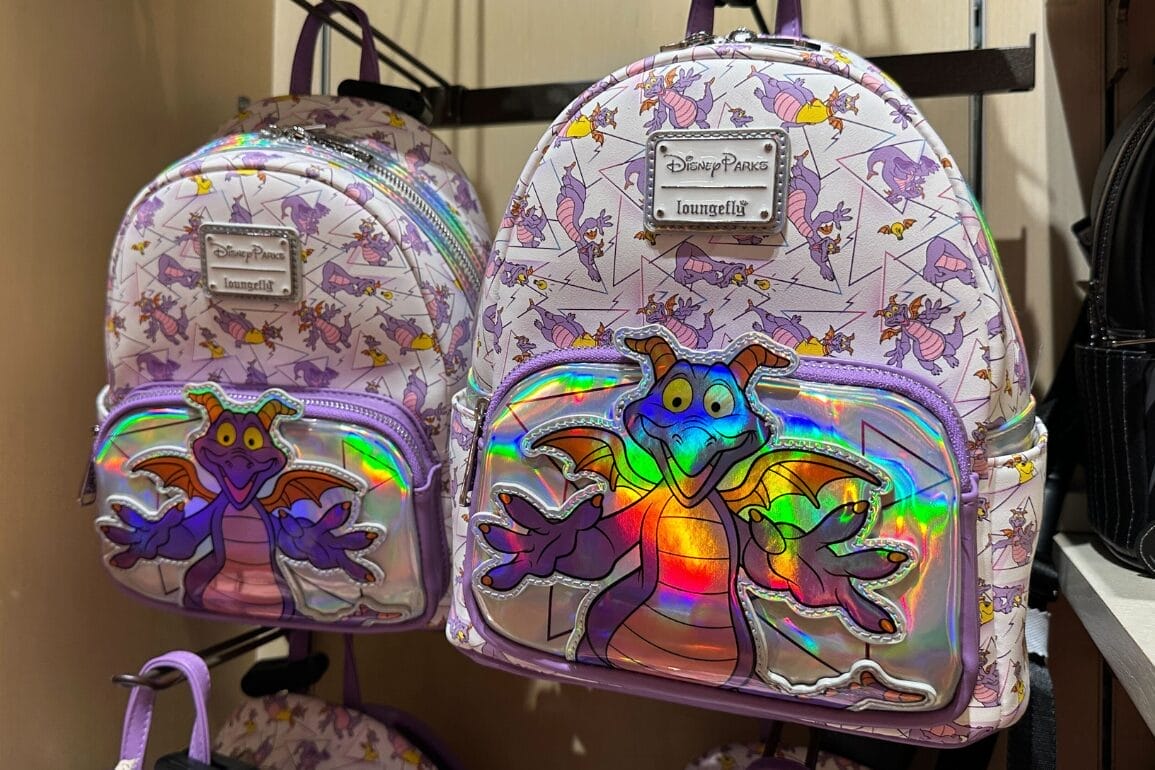 Two lavender Loungefly backpacks with shiny Figment designs, ideal for Disney park days—no castle like at Magic Kingdom shown.