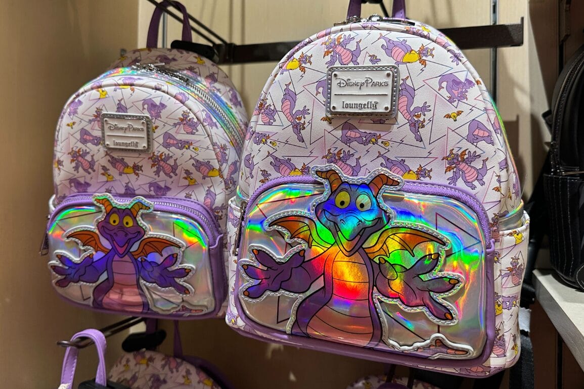Two pastel Figment Loungefly backpacks with whimsical dragon designs, seen at Disney Springs in Walt Disney World.