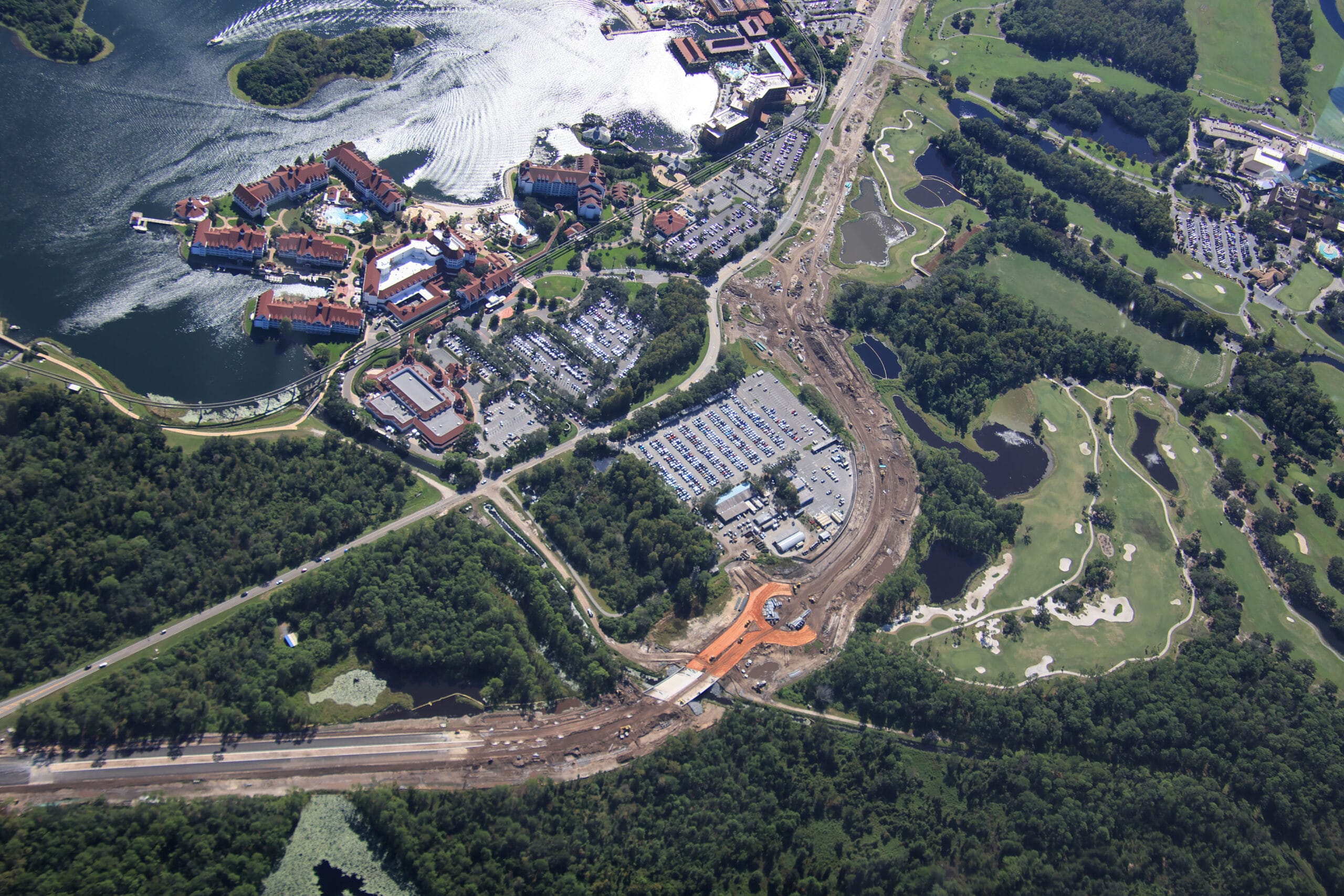 Aerial view of traffic circle construction by Disney’s Grand Floridian Resort, near a lake and lush greenery close to Magic Kingdom.