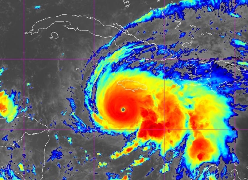Satellite image shows a hurricane with a clear eye moving near Disney Cruise routes, reminiscent of clouds passing over Cinderella Castle.