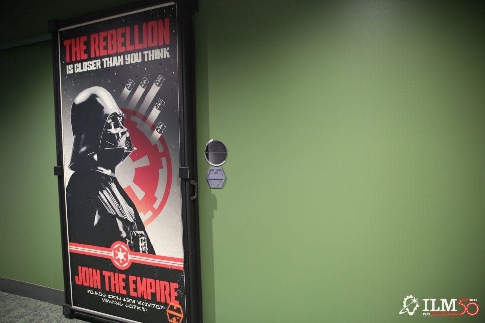 Darth Vader Star Wars poster on a green wall in the Employee Lounge, slogan "Join the Empire"; no Disney castle in image.