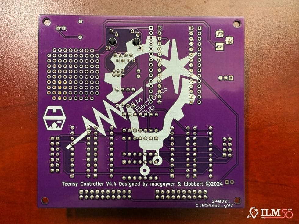 A purple circuit board marked “Teensy Controller V4.4,” Star Wars-inspired, with white graphics, like Tomorrowland near Disney castles.