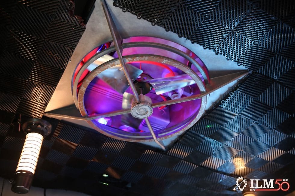 Large industrial ceiling fan with purple lights and soundproof panels in Lucasfilm Lounge, ILM 50th logo—no Disney castle visible.