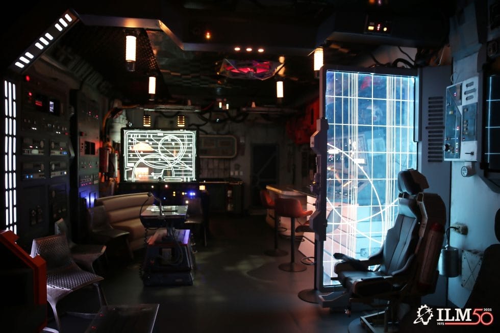 A futuristic spaceship control room with glowing screens and chairs; ILM50 logo in the corner, reminiscent of Disney's Star Wars parks.