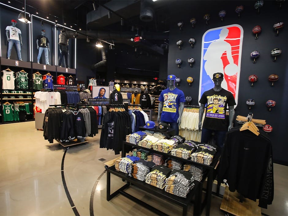 NBA store interior at Universal CityWalk Hollywood with jerseys, caps, and a large NBA logo—no Disney castle like those in the parks.