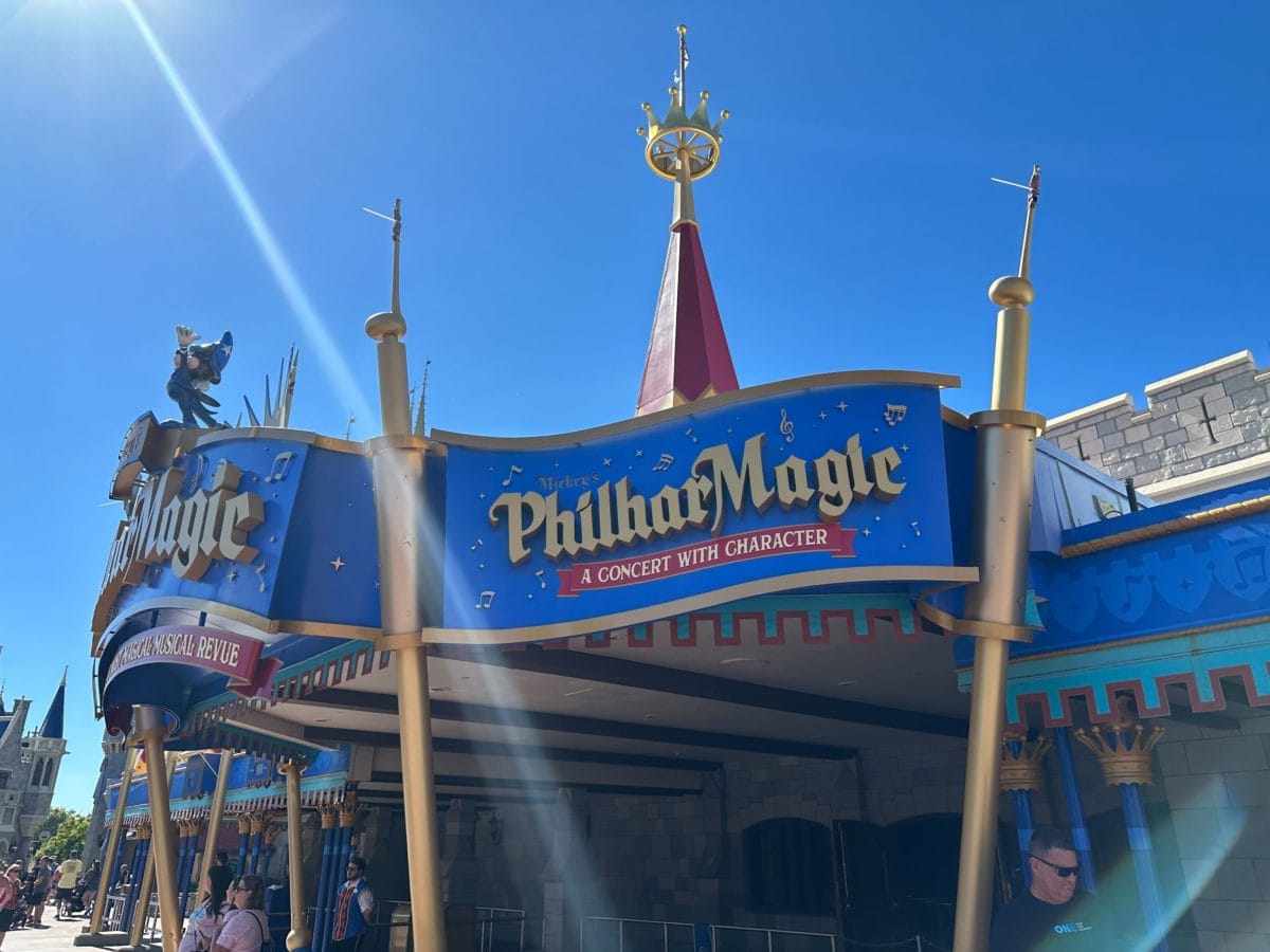 “Mickey’s PhilharMagic” entrance sign pops against a bright blue sky at Magic Kingdom in Walt Disney World.