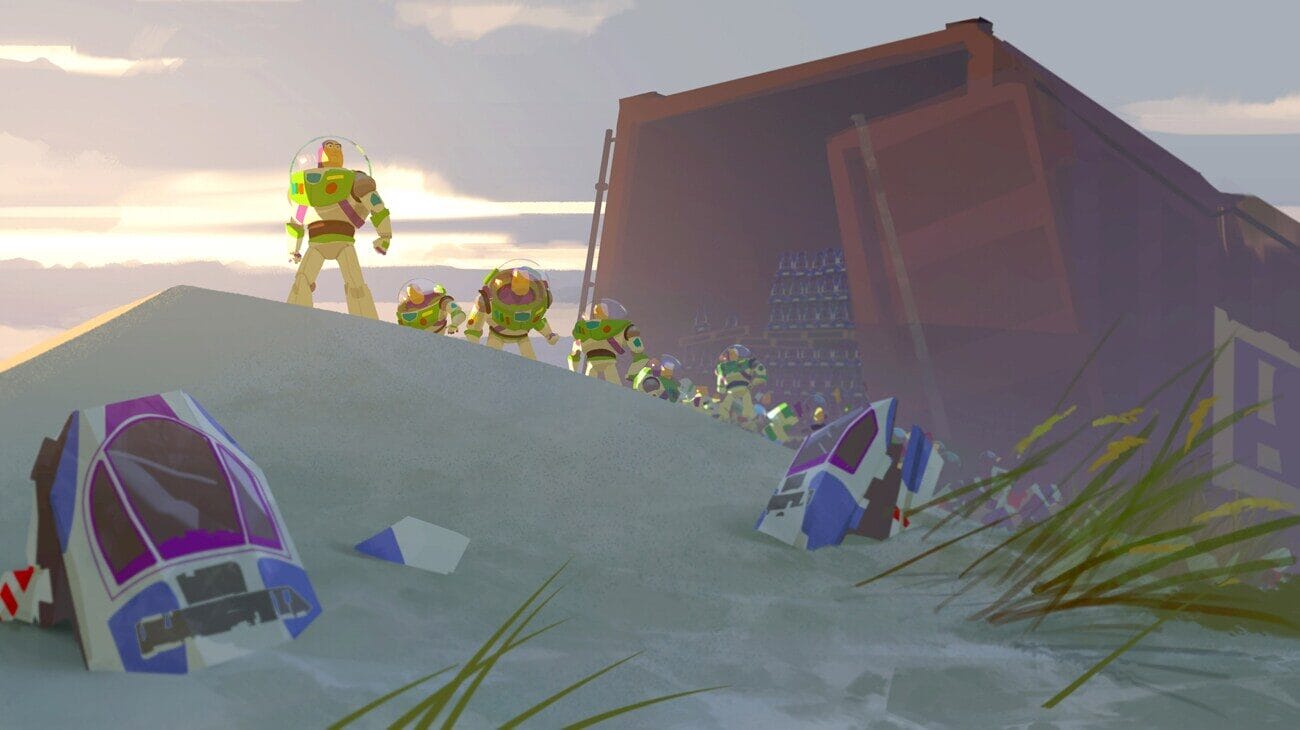 Several Buzz Lightyear toys walk in a line on sand near a rusted container, evoking Toy Story Land at Disney parks worldwide.